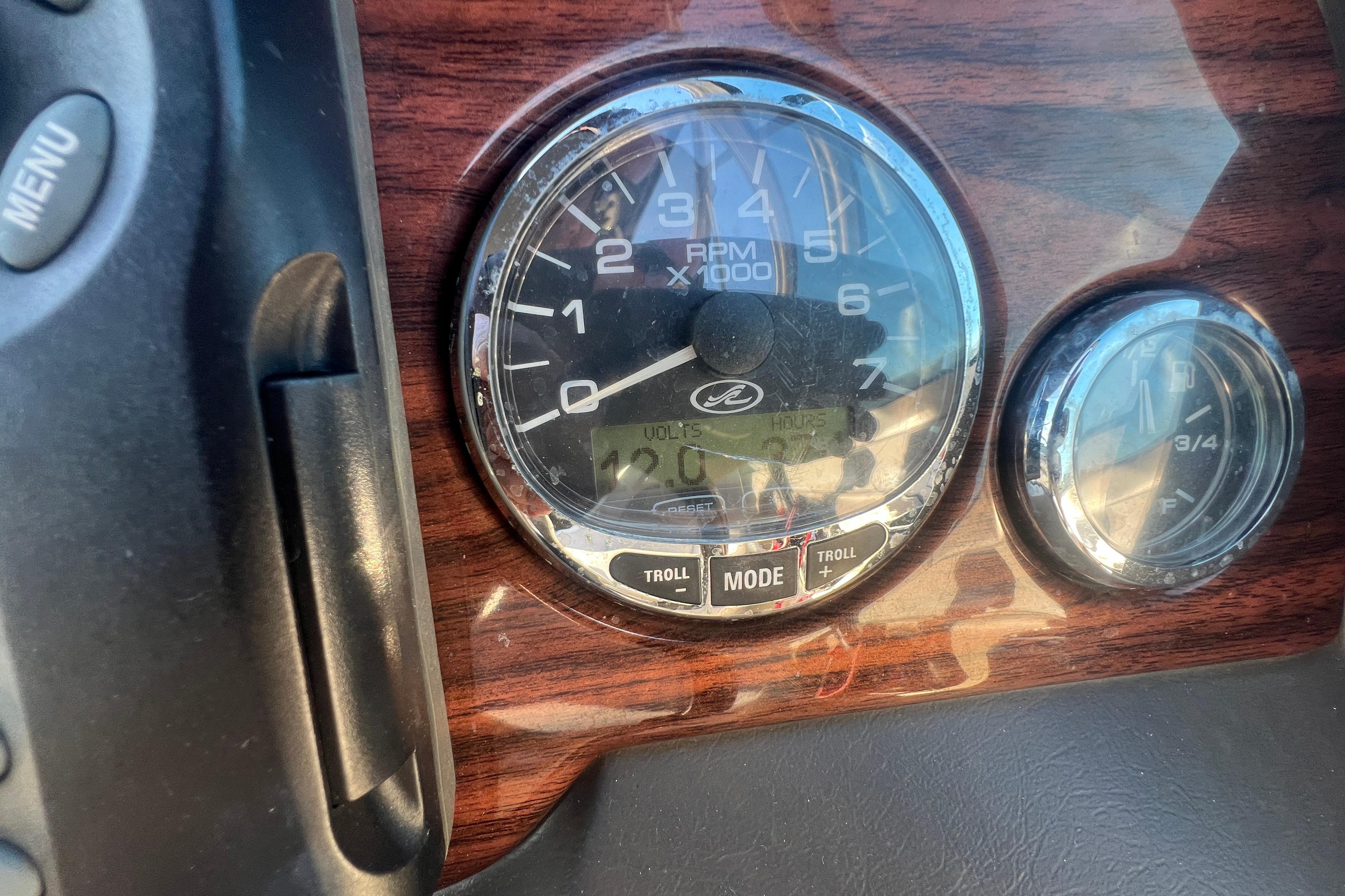 Close-up of 2009 Sea Ray 210 Sundeck dashboard with RPM gauge and controls.