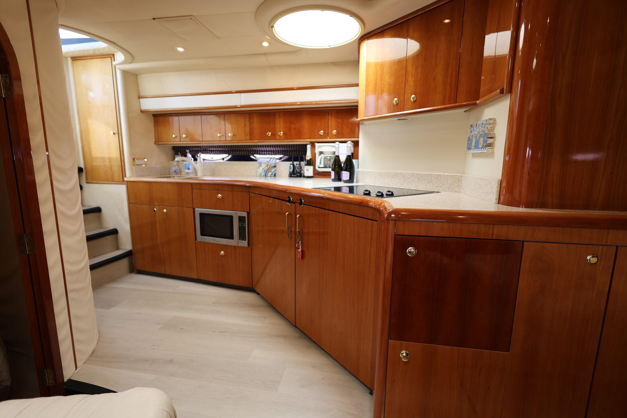 Luxurious wooden kitchen interior of 1999 Neptunus 54 Express yacht.