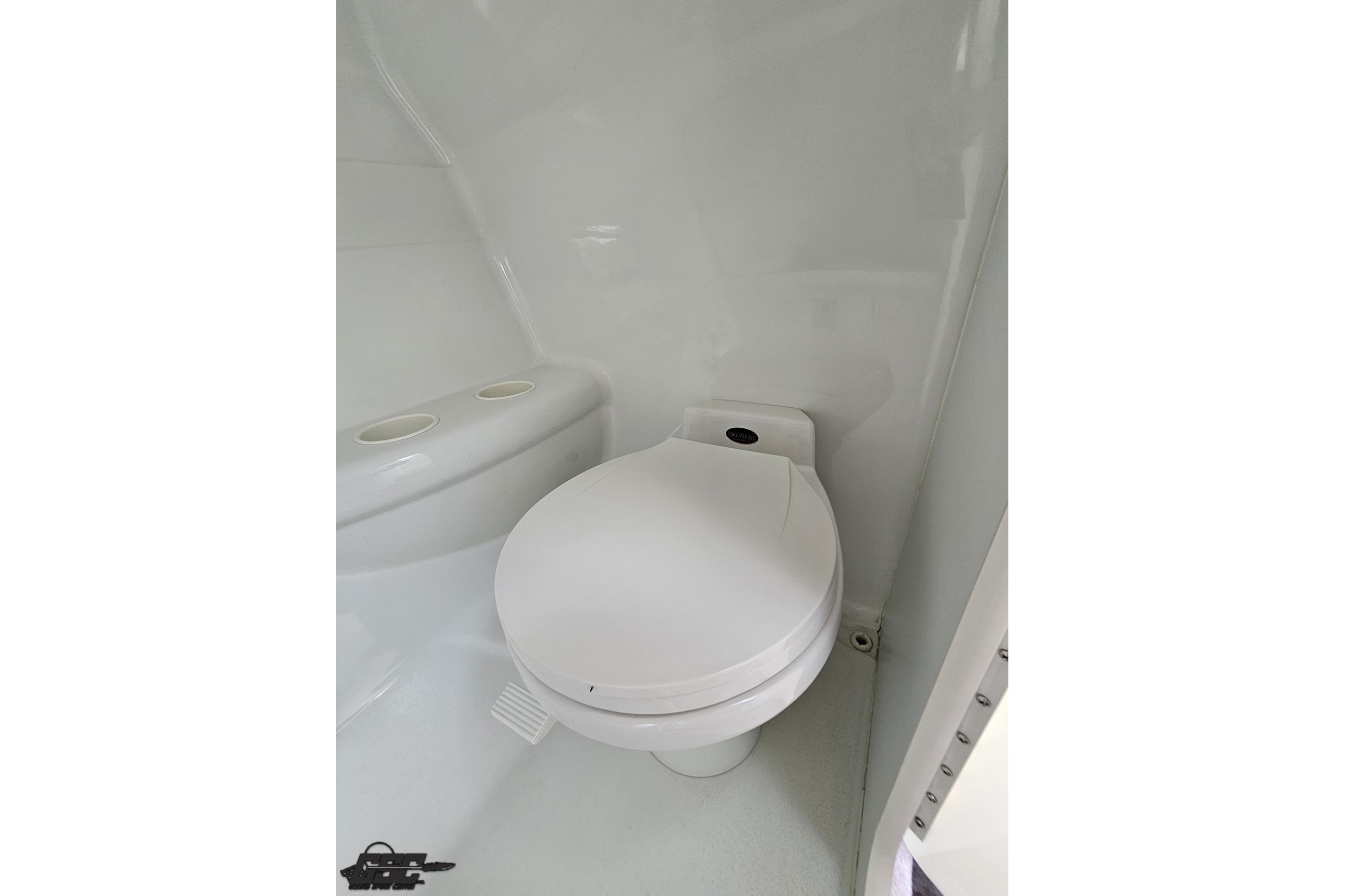 2002 Formula 382 FASTech boat bathroom with compact white toilet.