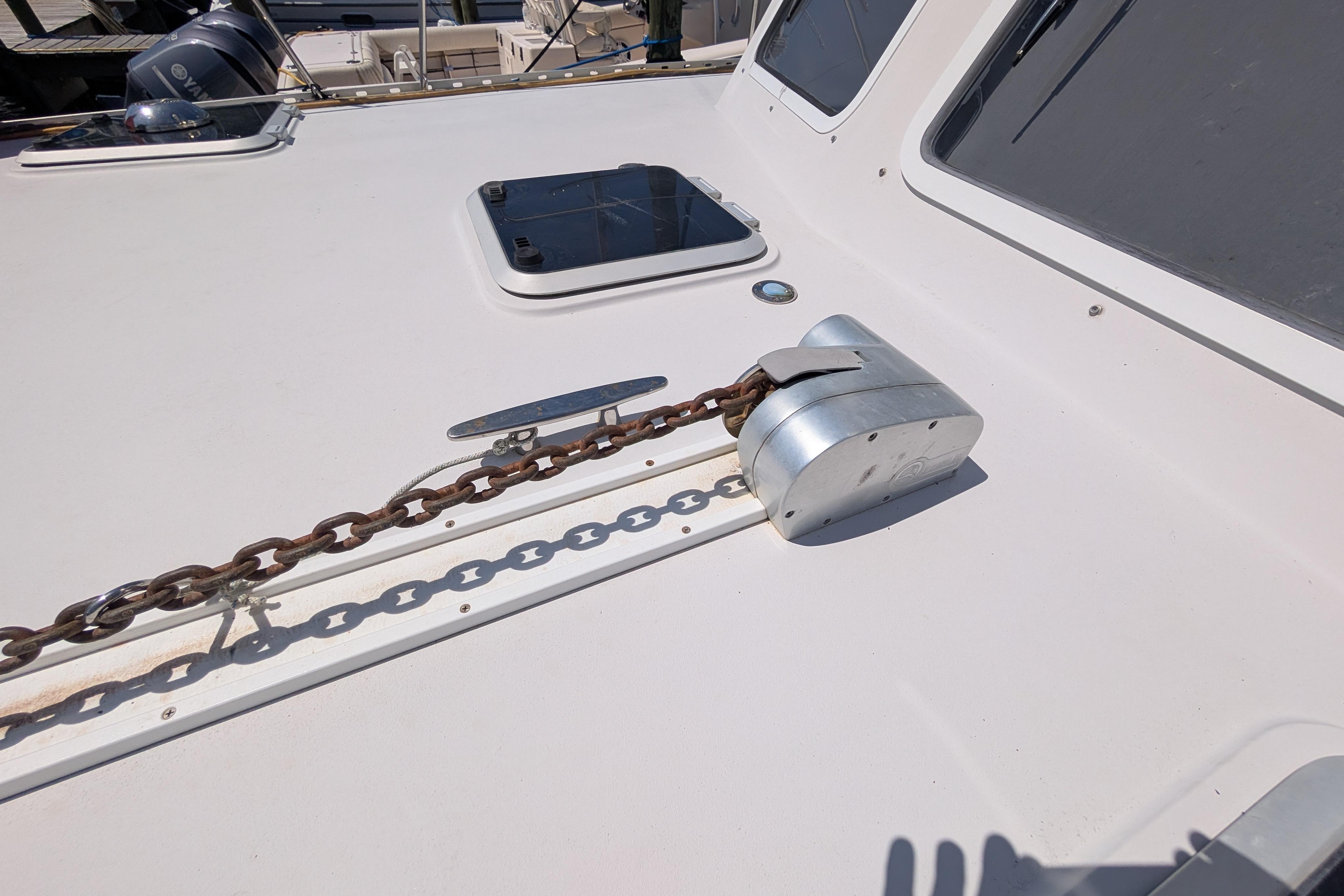 Deck of 2004 PDQ 34 Powercat with anchor chain and hatch.