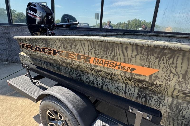 2026 Tracker Grizzly 1756 T Marsh boat with camouflage design on a trailer.