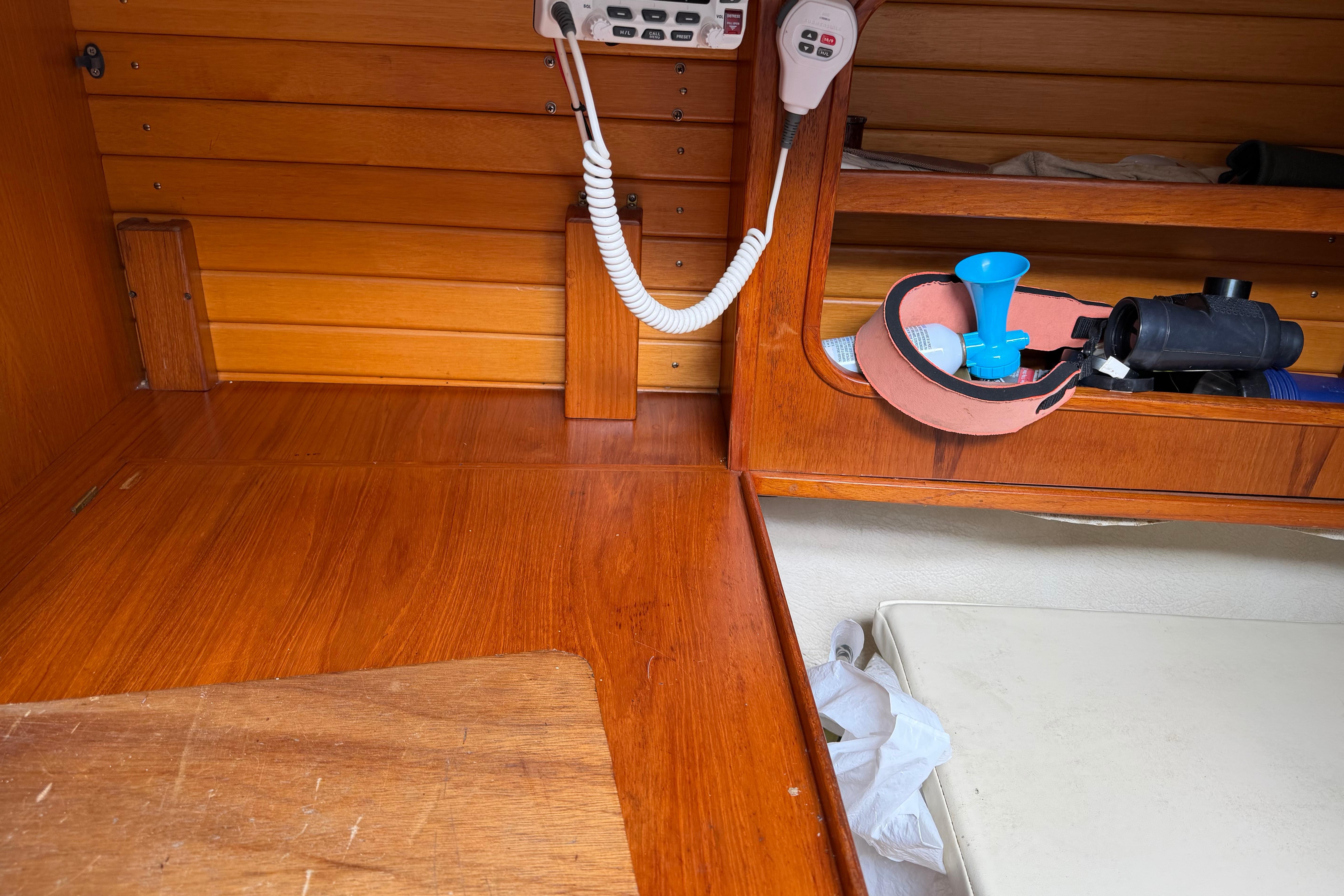 Interior of 1986 Victoria 34 Sloop with wooden paneling and marine equipment.
