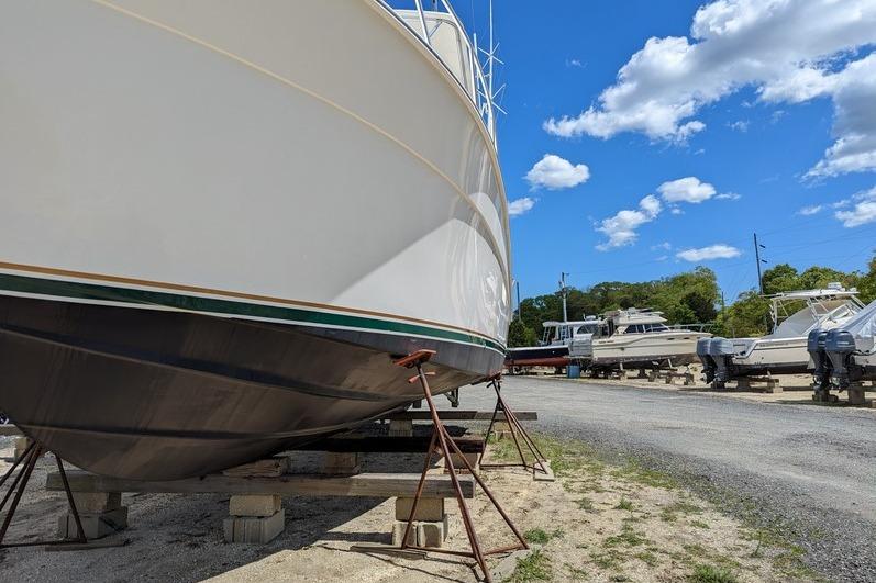 2005 Egg Harbor 43 SportYacht on dry dock under a clear blue sky.