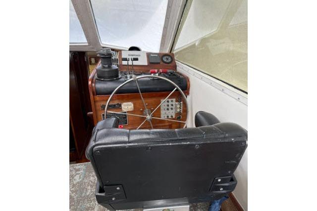1982 Lancer 45 Motorsailer helm with steering wheel and navigation equipment.