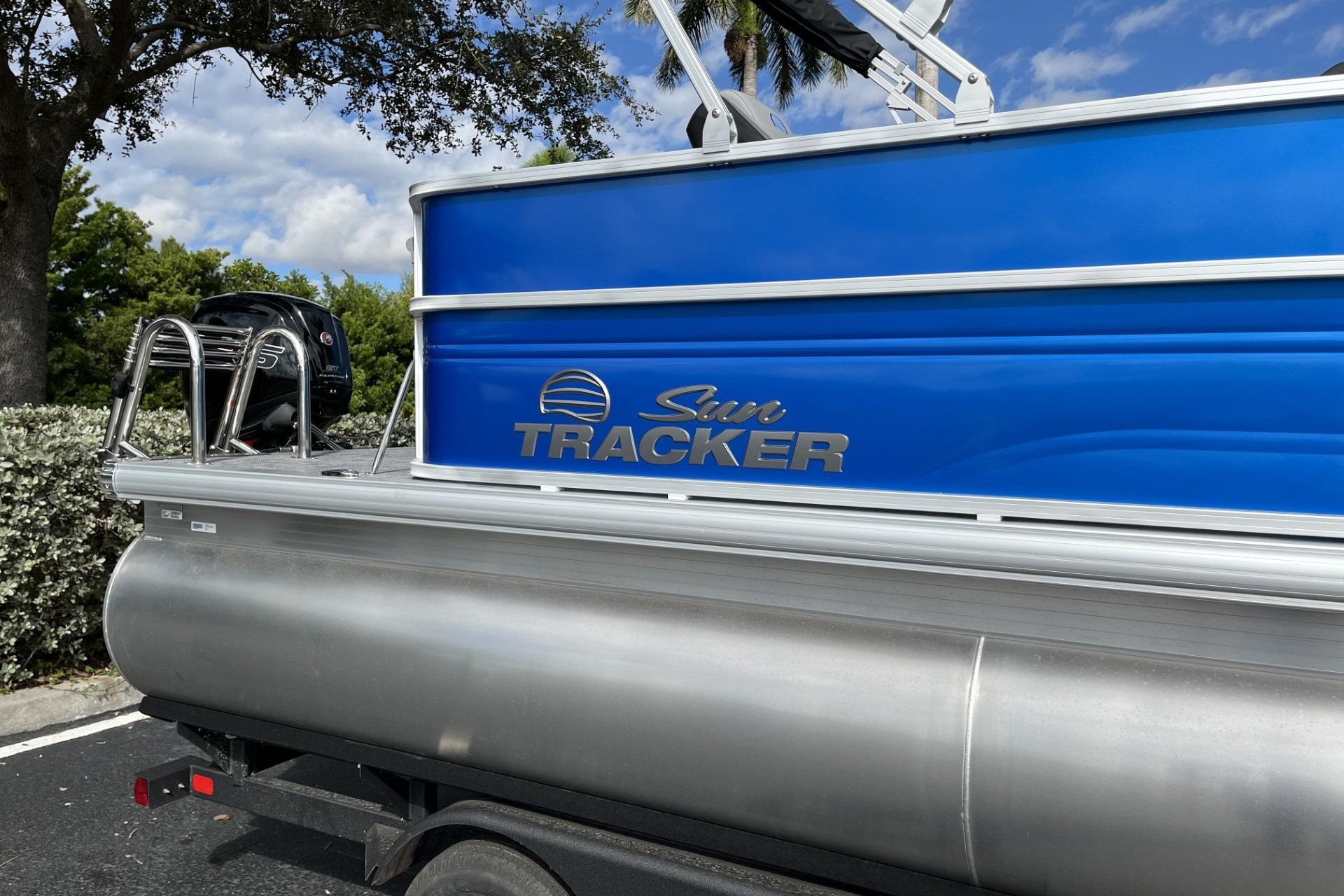 2026 Sun Tracker Party Barge 20 DLX pontoon boat with blue exterior and silver accents.