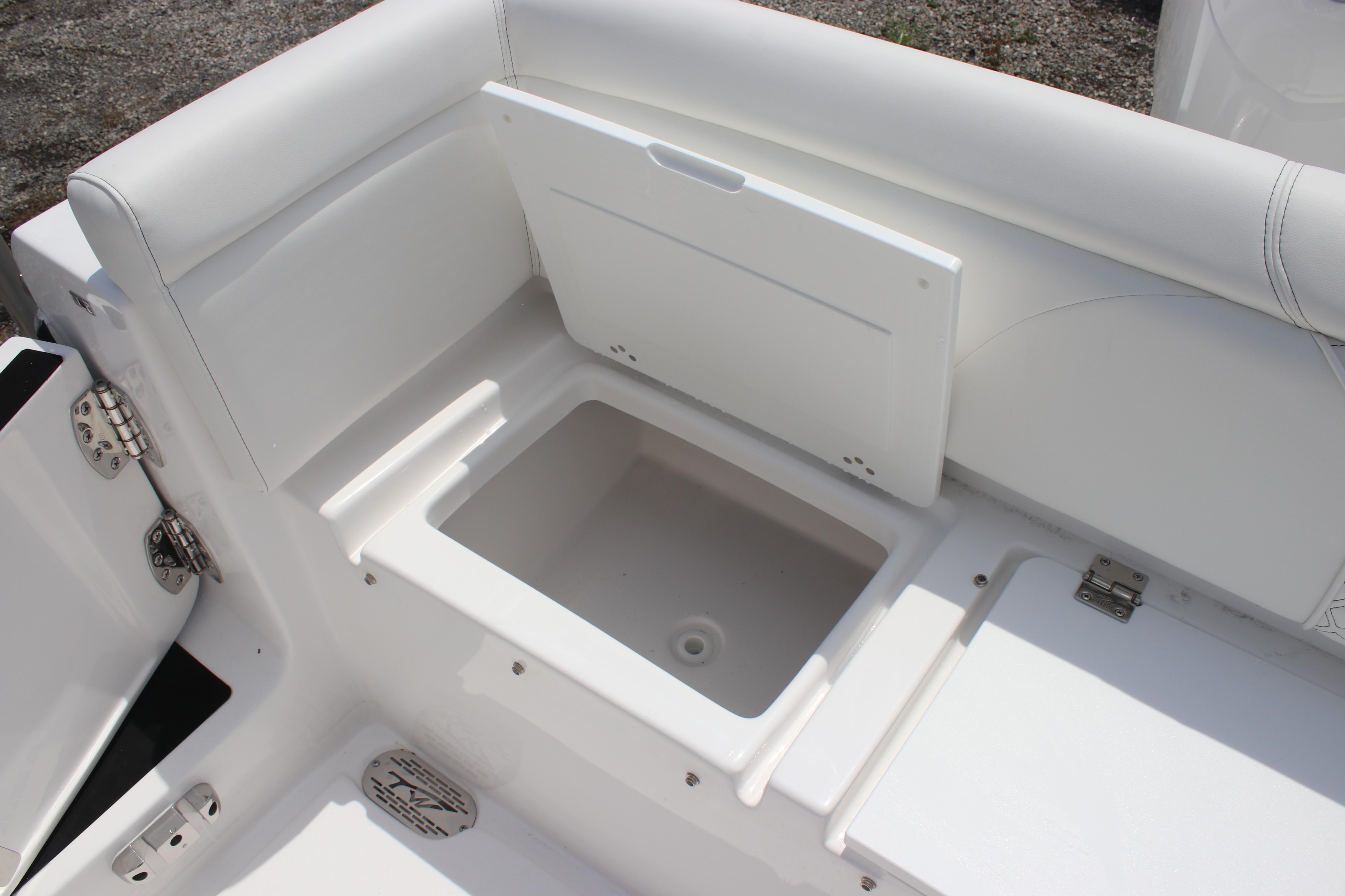 2026 Tidewater 272 LXF boat storage compartment with open lid, showcasing sleek white interior design.