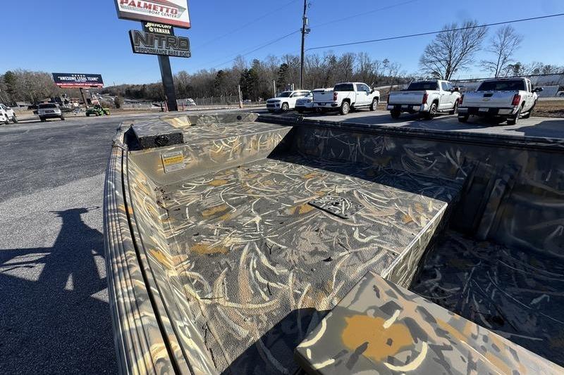 2026 War Eagle 648LDV boat with camouflage design in a parking lot setting.