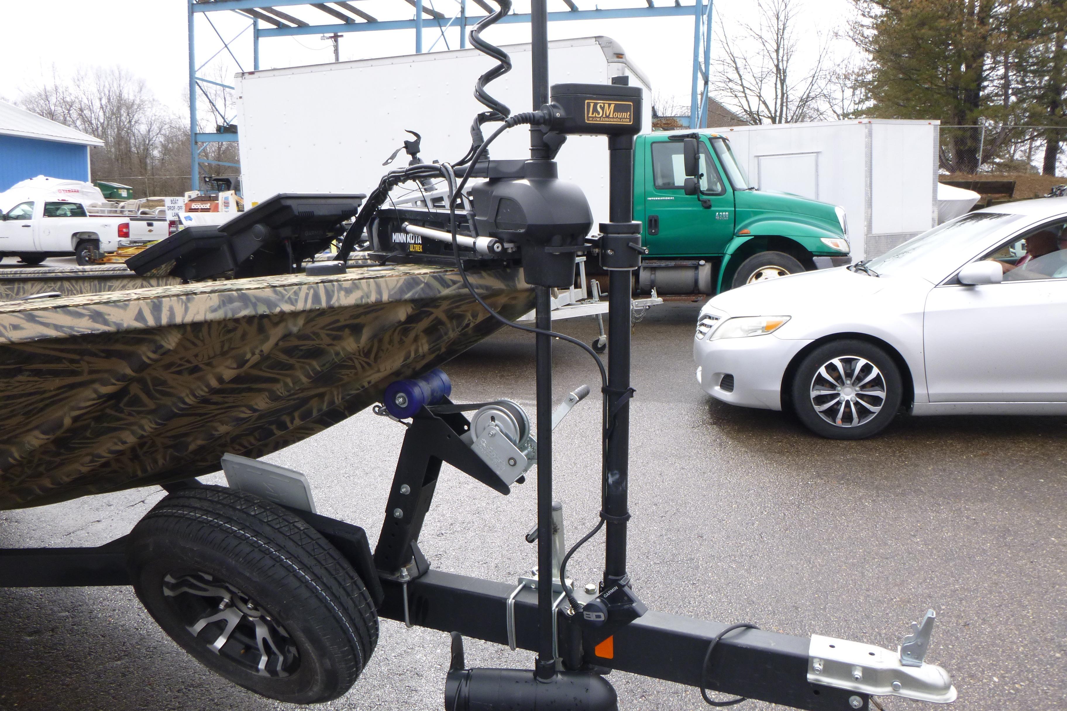 2024 Lowe Roughneck 2070 boat on trailer, featuring a mounted trolling motor.