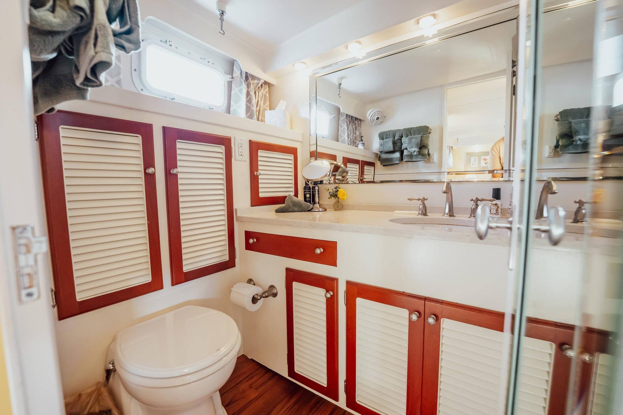 Luxurious bathroom on a 1972 Trumpy 72 Motor Yacht with elegant cabinetry and fixtures.