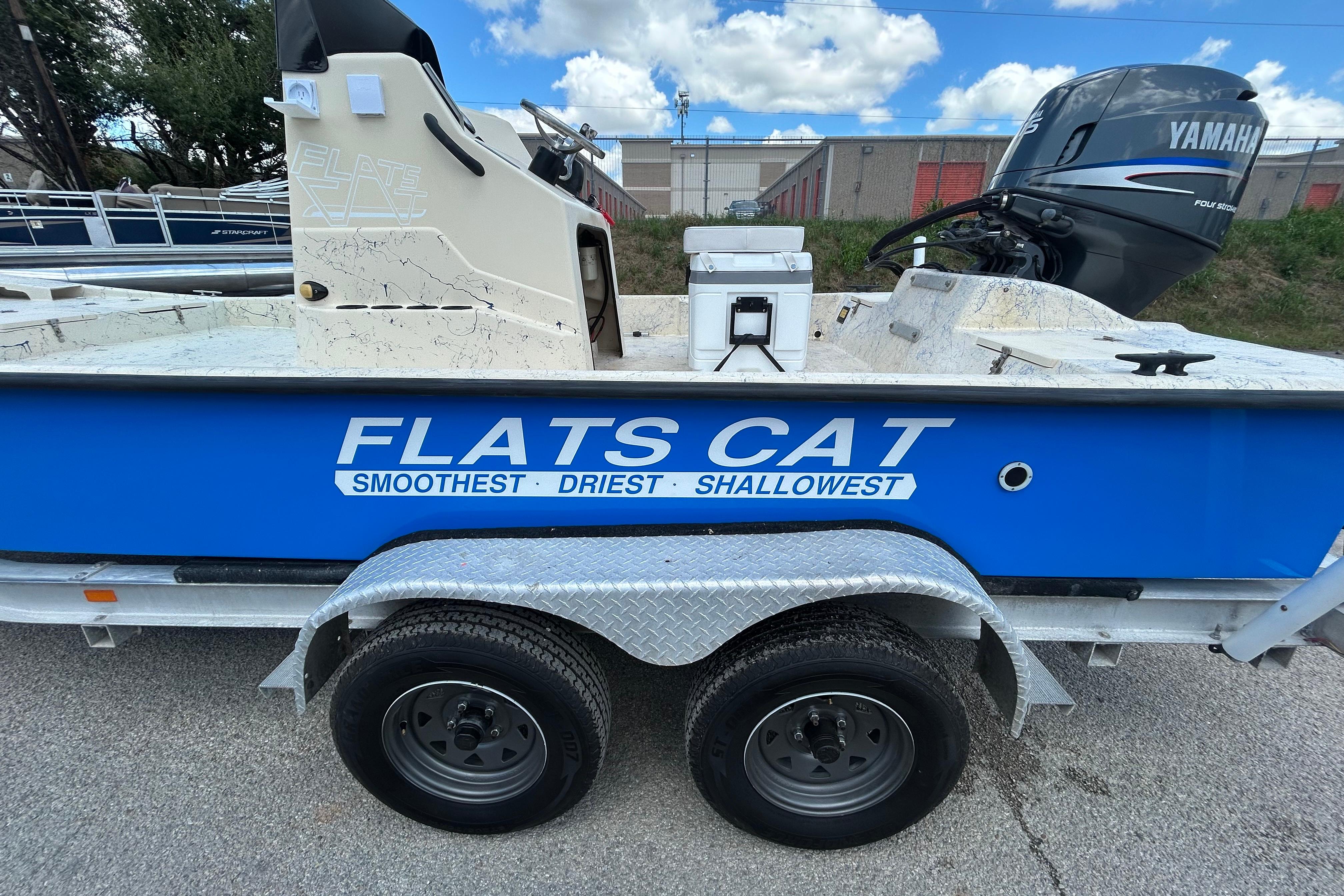 2007 Flats Cat 19 boat on trailer with Yamaha engine, blue and white design.