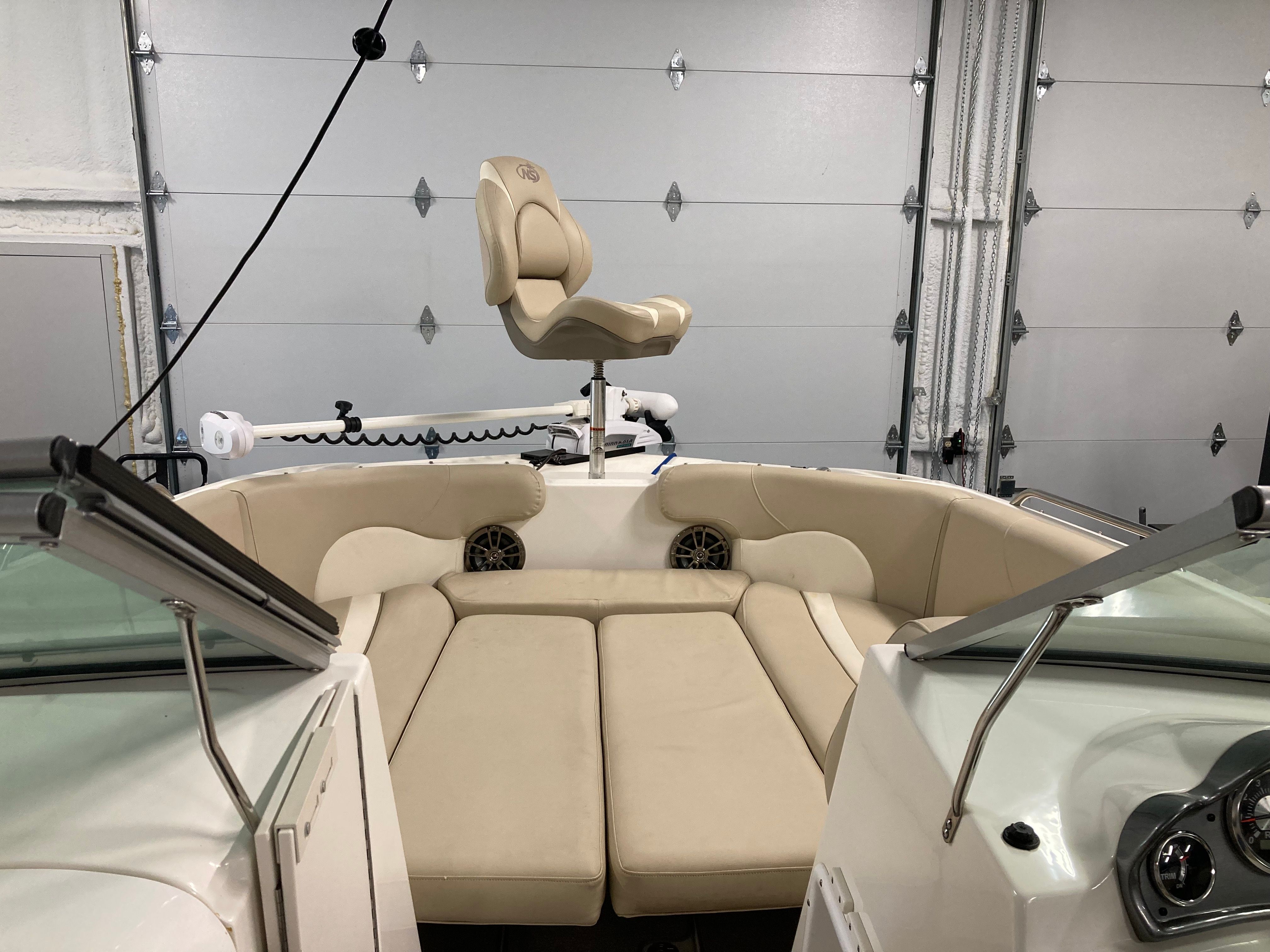 2016 Custom 223 DC with beige upholstery and helm station.