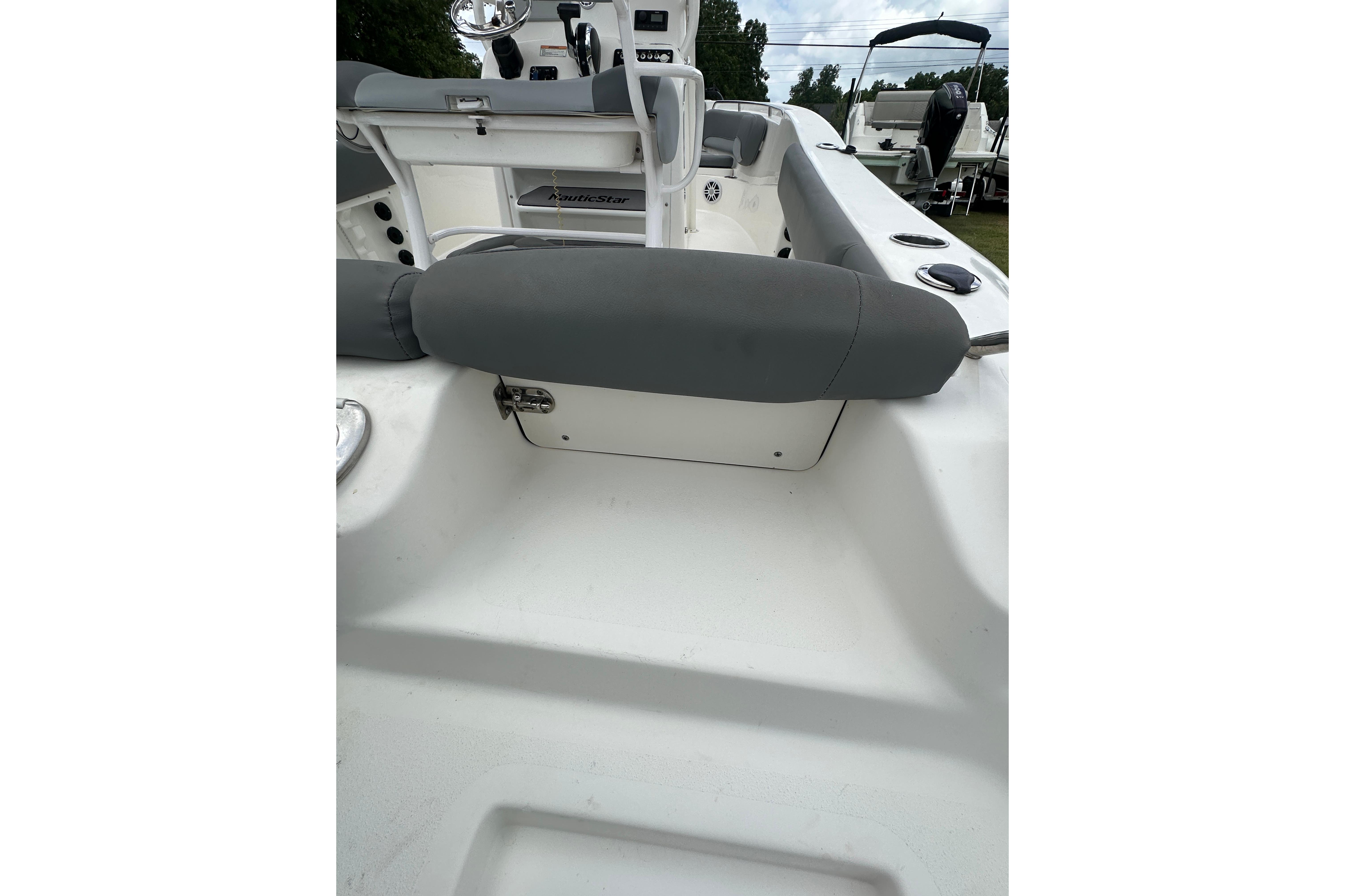 2023 NauticStar 2102 Legacy boat interior with gray seating and console view.