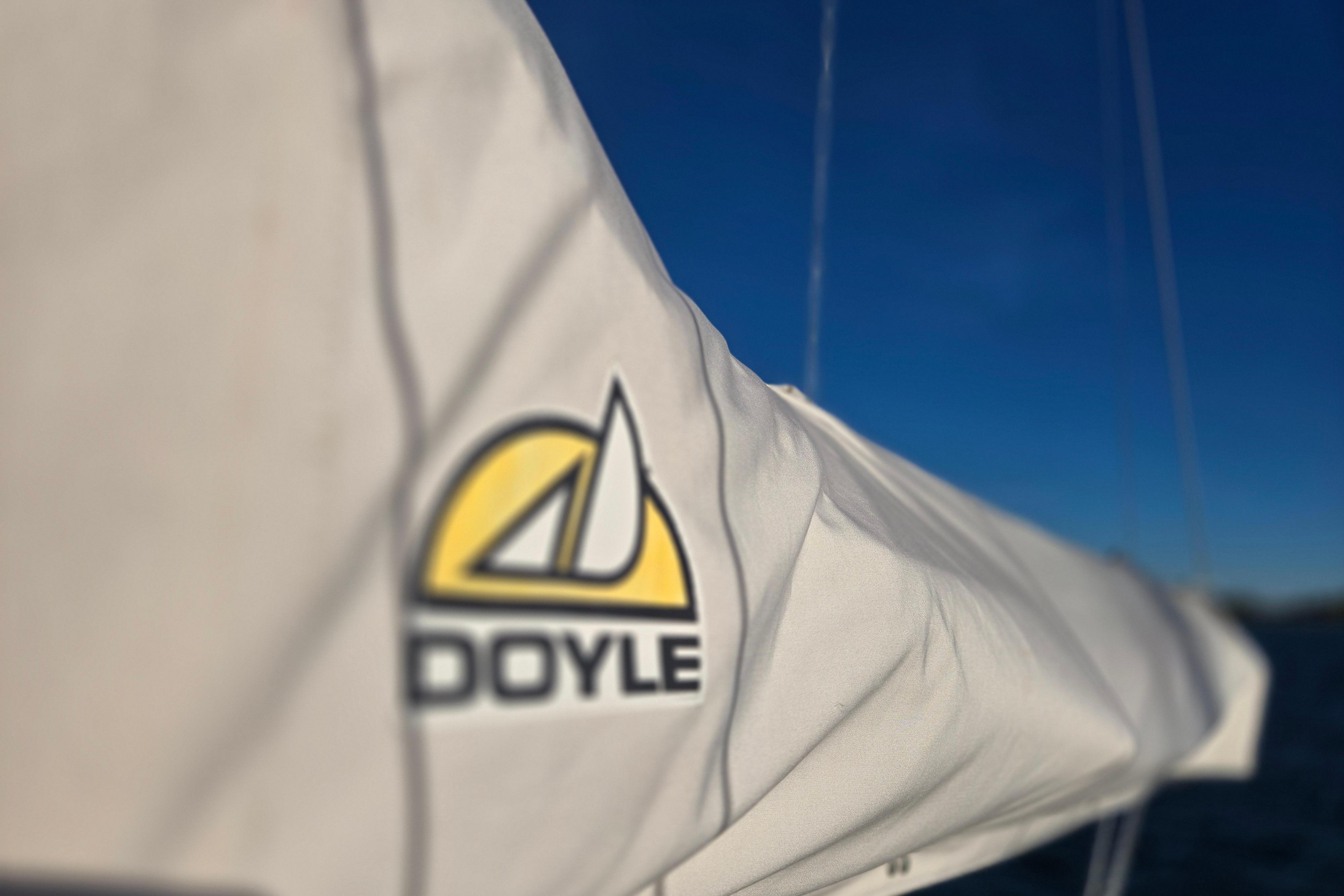 Close-up of Doyle sail on 1970 Hinckley Bermuda 40 yacht against clear blue sky.
