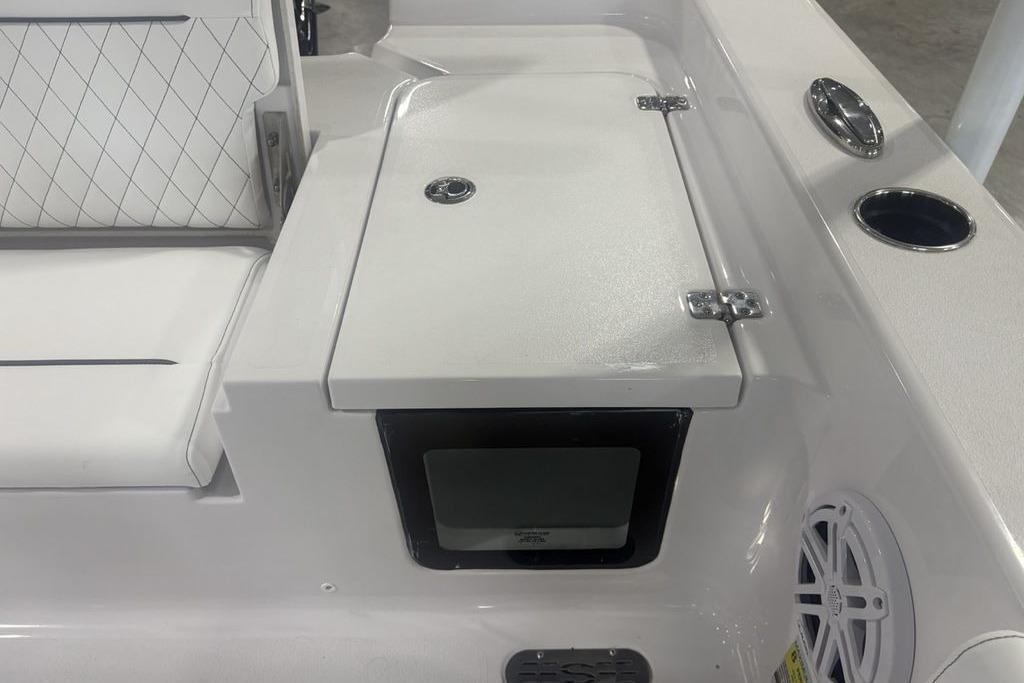 2026 Sportsman Masters 227 boat interior with cushioned seating and storage compartment.