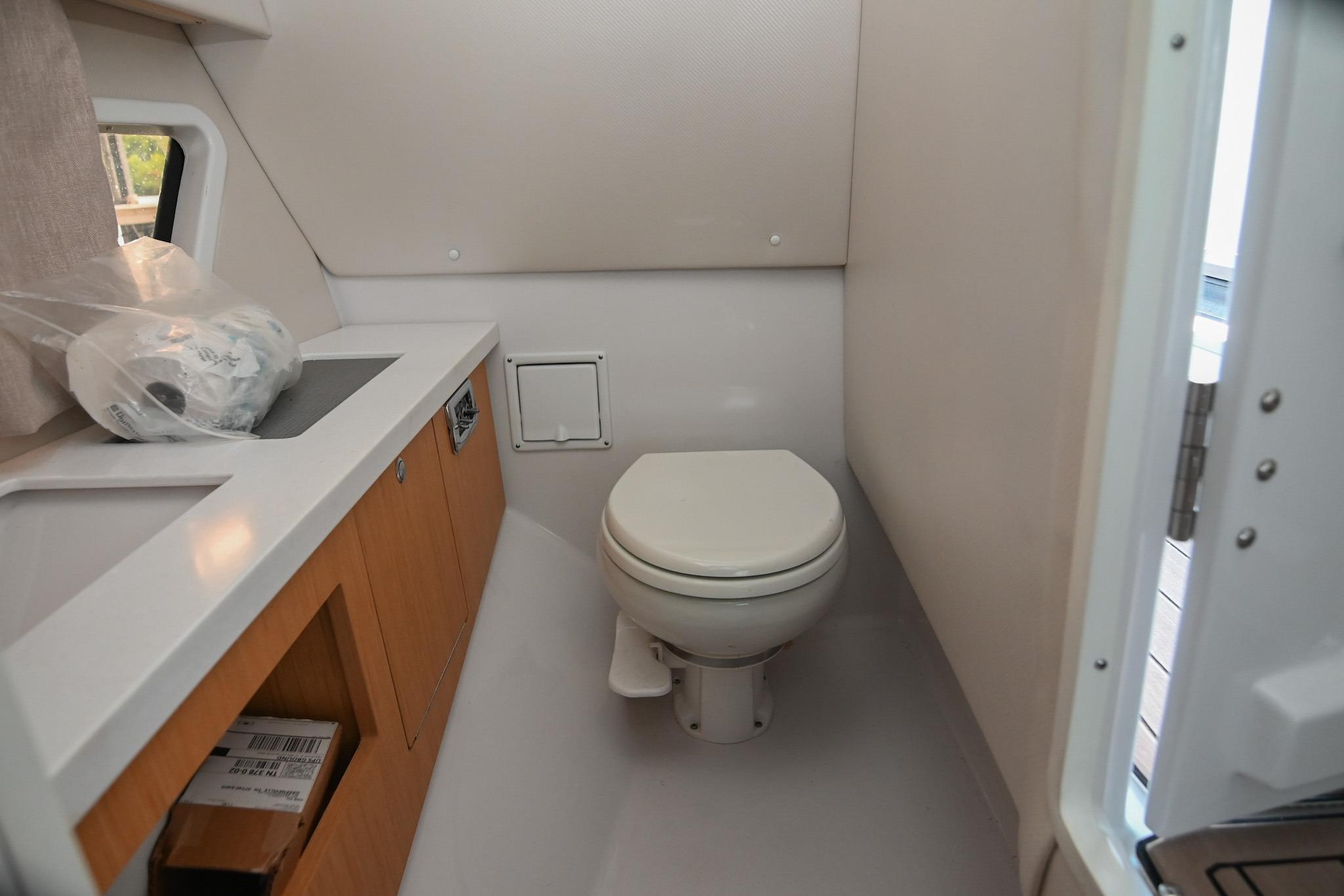 2014 Four Winns H290 boat bathroom interior with toilet and sink.