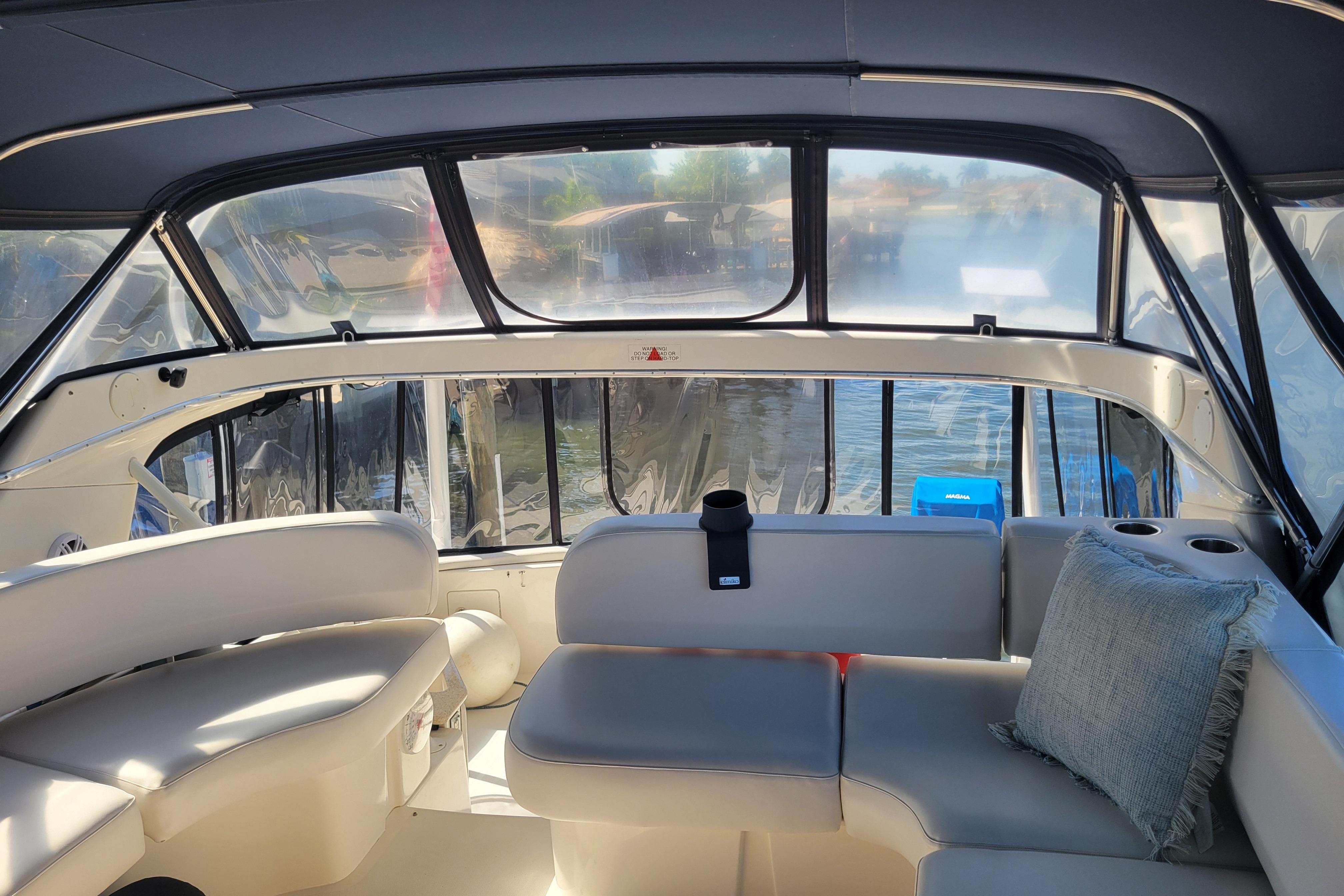 Interior of 2005 Silverton 43 Motor Yacht with plush seating and panoramic windows.
