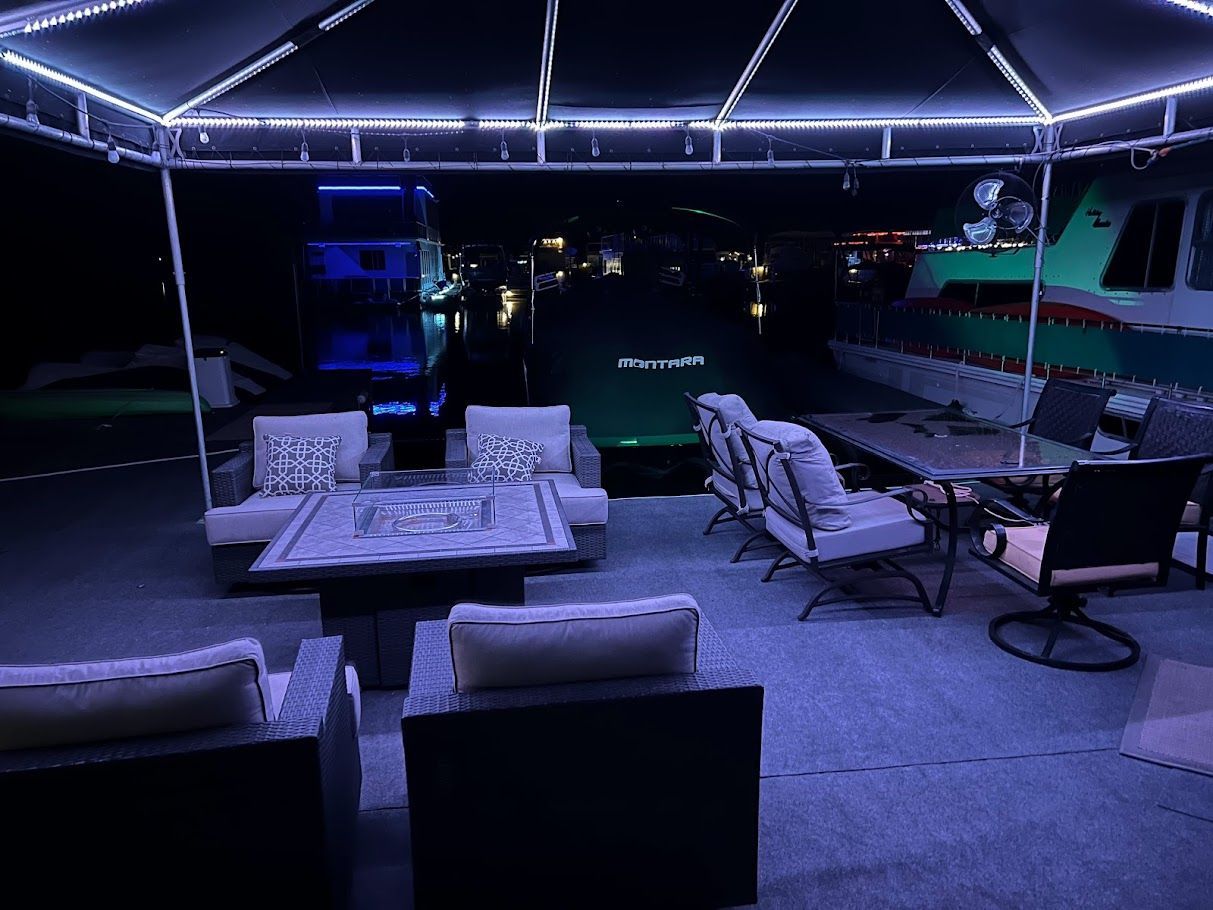 Illuminated deck of a 2006 Summersun Houseboats 16x68 at night.