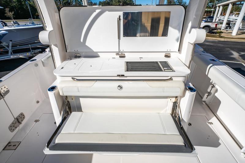 2025 Edgewater 370CC boat interior with seating and grill station.