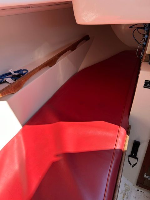 Interior of a 1969 Morgan 30 with red upholstery and wooden details.