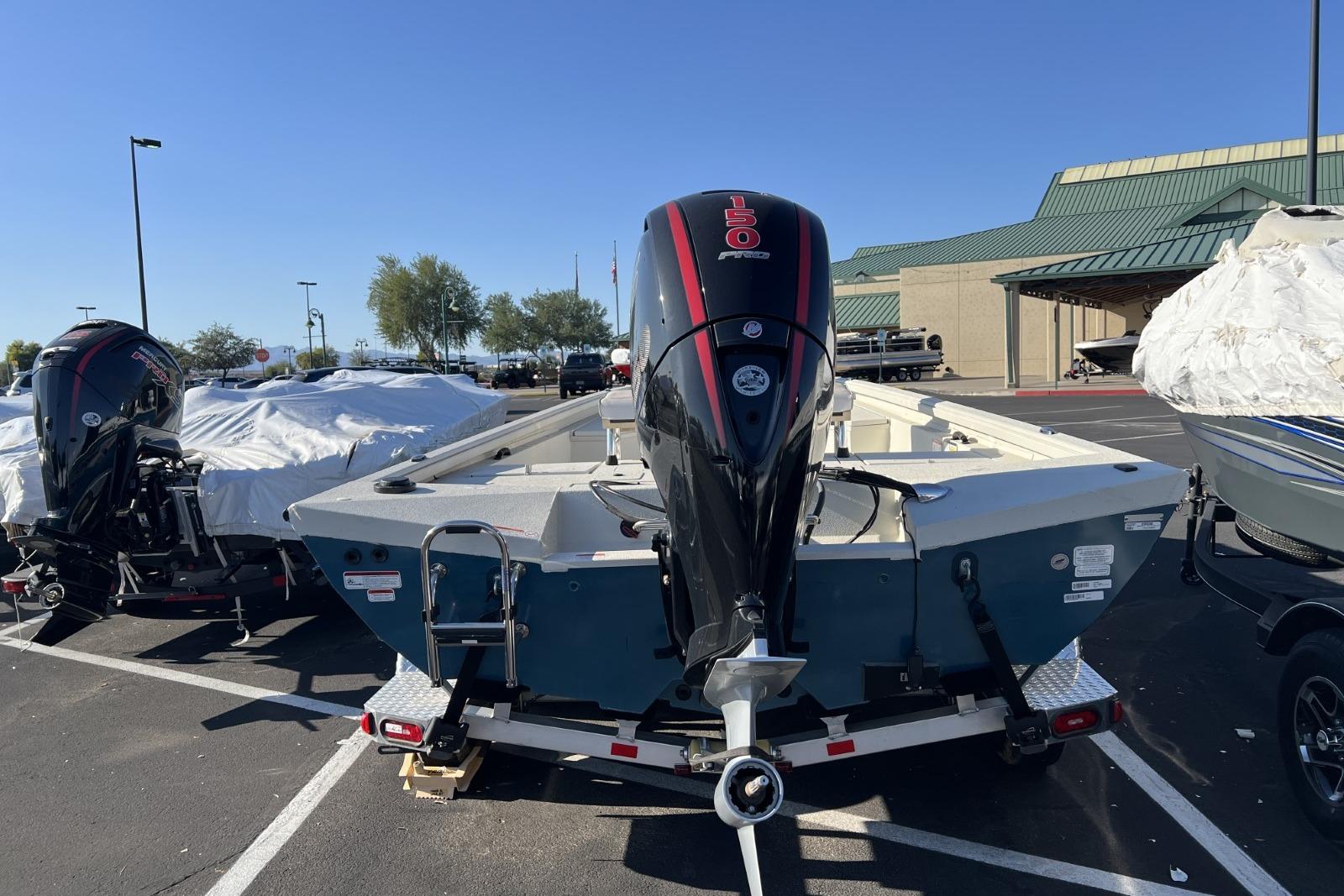 2024 Ranger RB200 boat with powerful outboard motor in a parking lot.