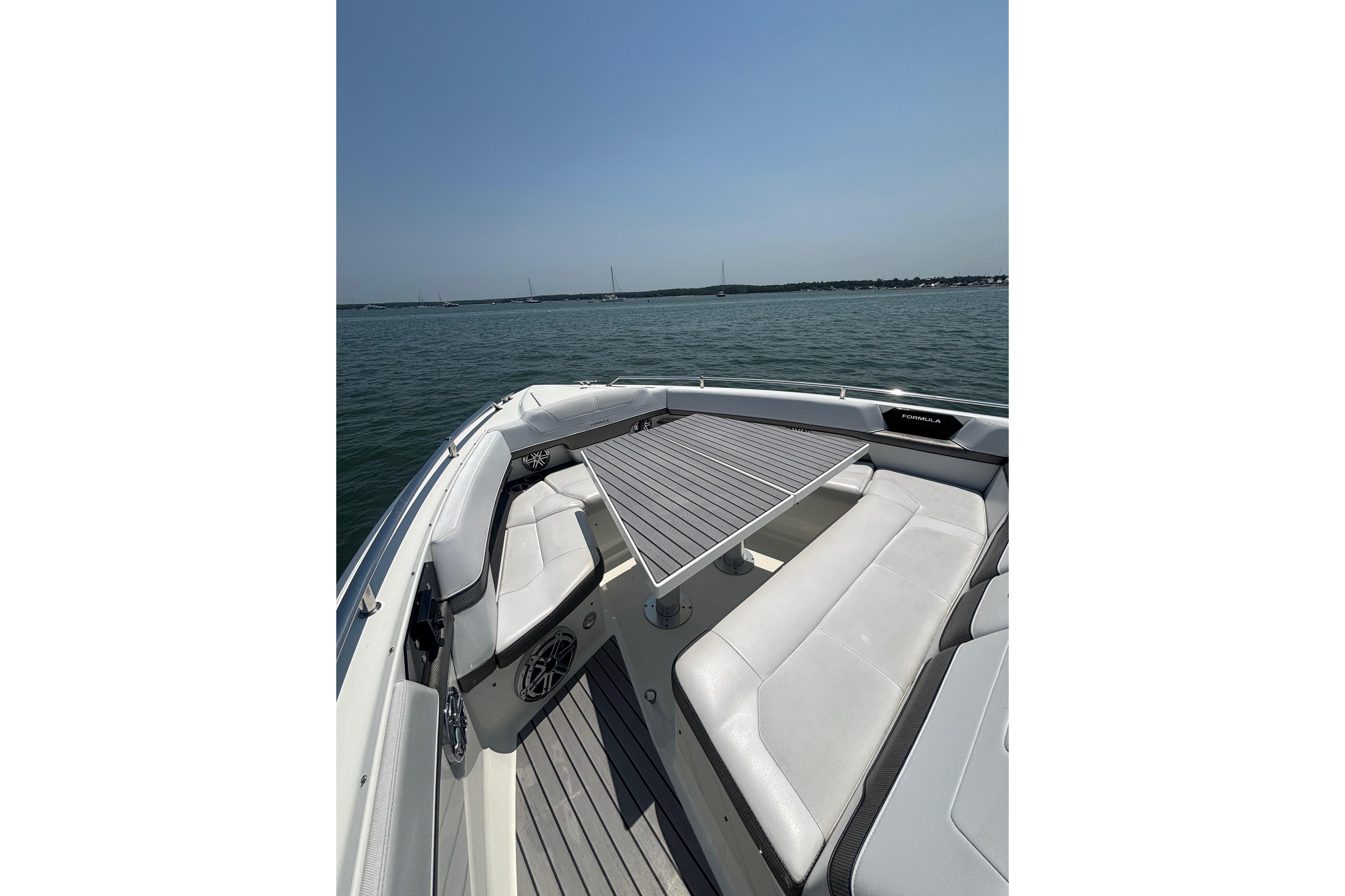 2019 Formula 430 Super Sport Crossover boat interior with seating and table on open water.