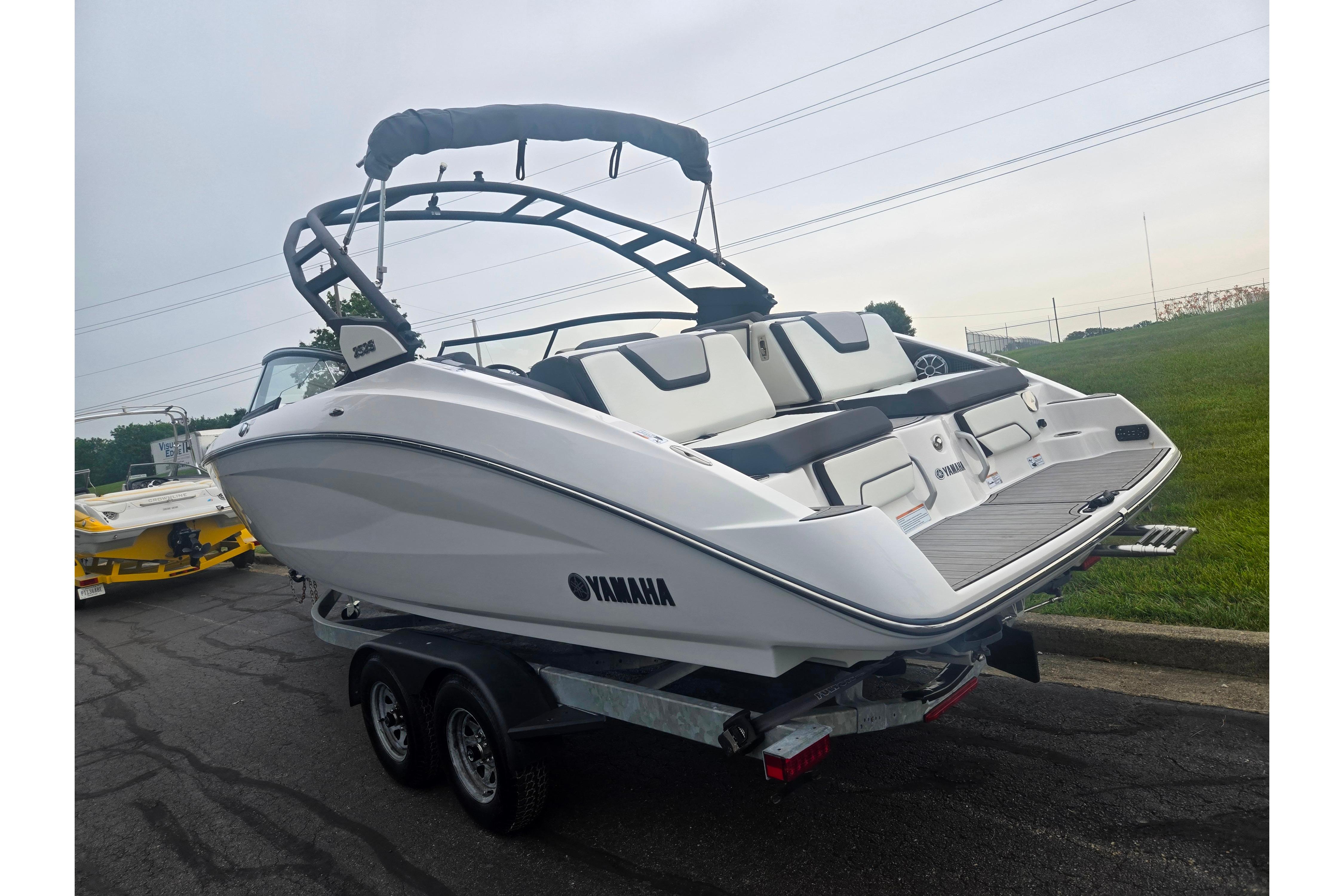 2023 Yamaha Boats 252S on trailer, sleek design, white exterior, outdoor setting.