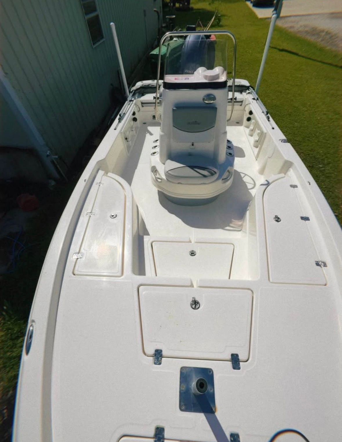 The image shows a 2022 Custom 215 XTS boat with an open deck and a helm station.
