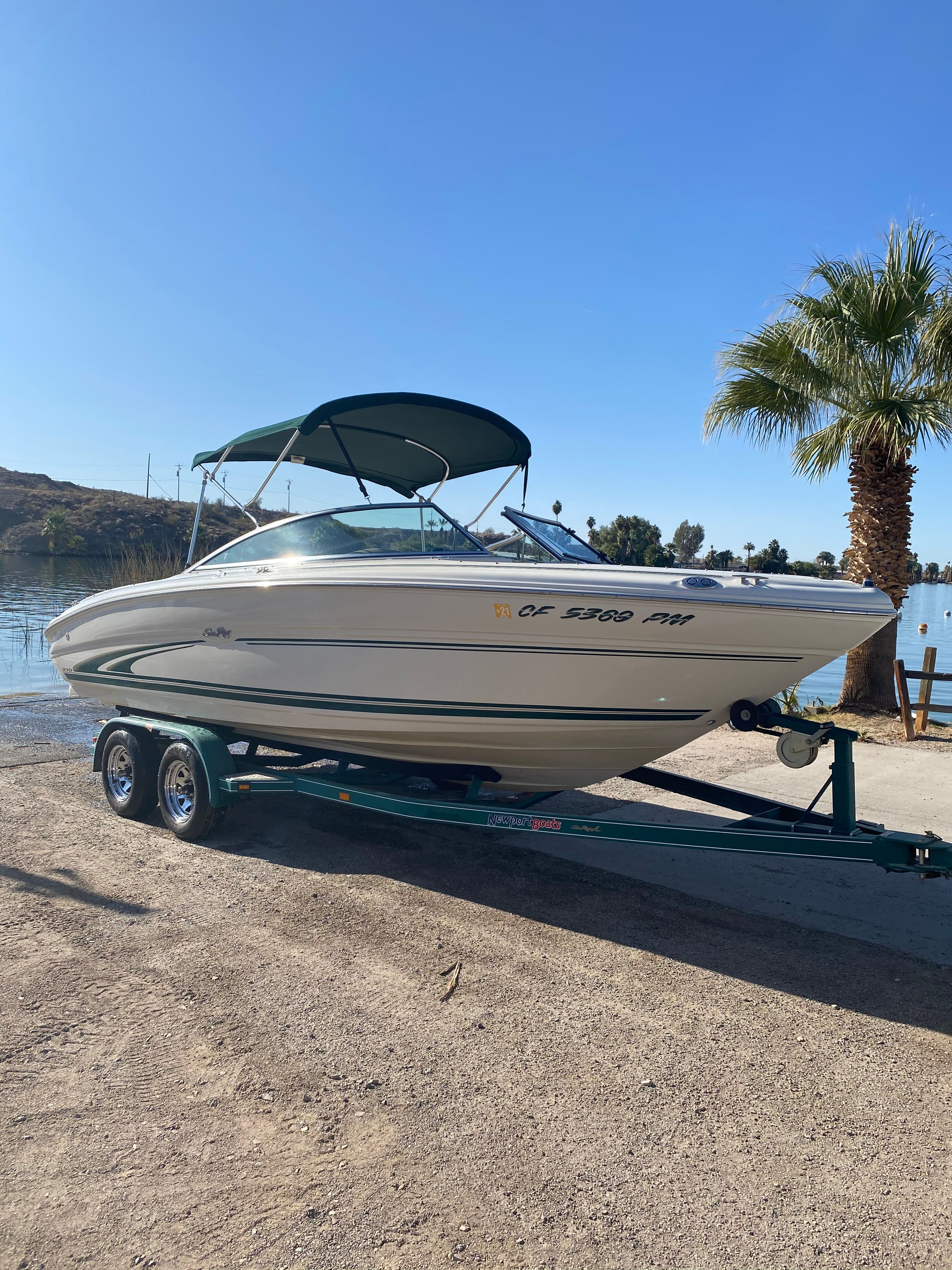 2000 Sea Ray Signature Series boat on trailer by the lake.