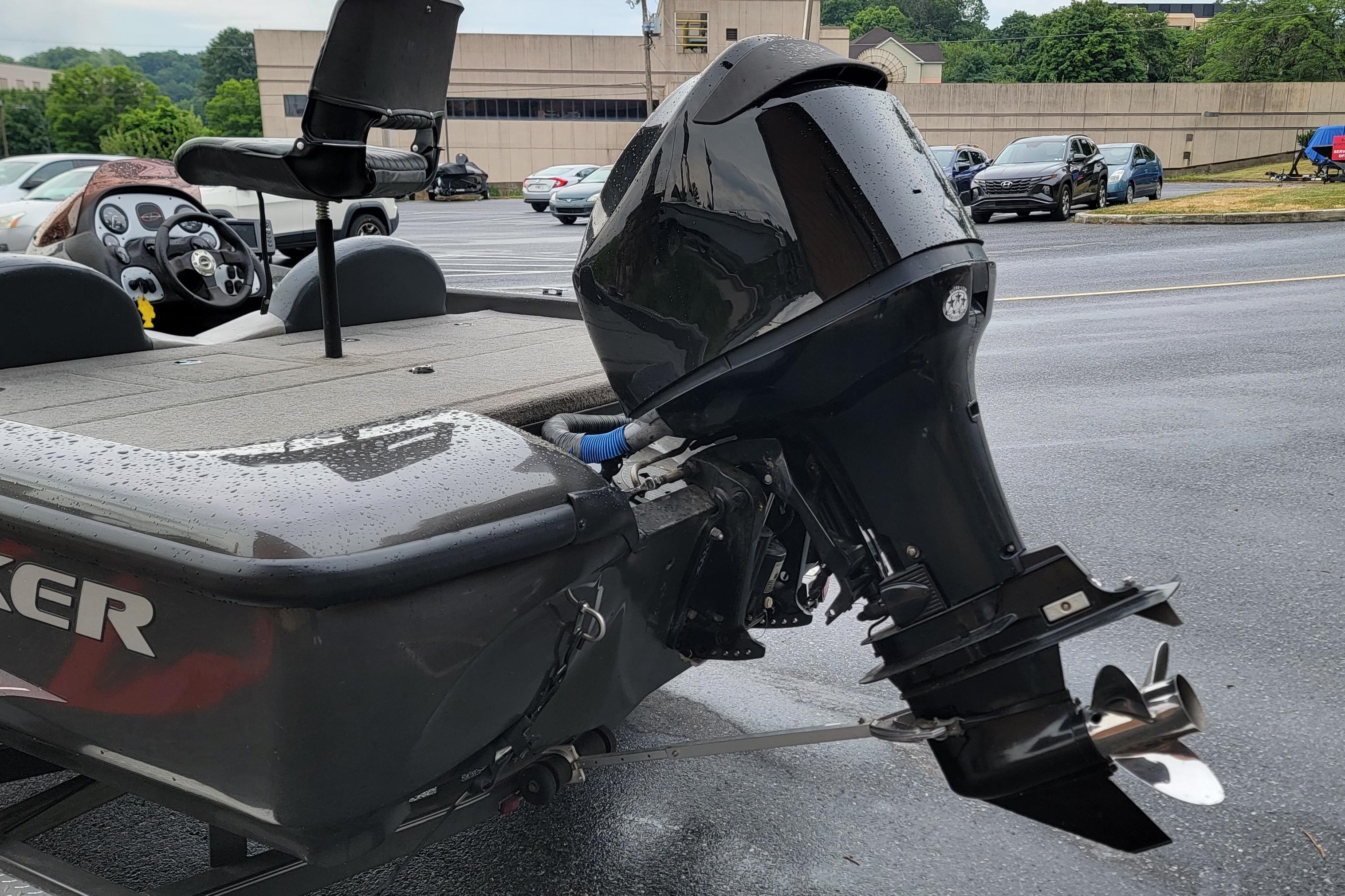 2006 Tracker Avalanche 18 SC boat with outboard motor in a parking lot.