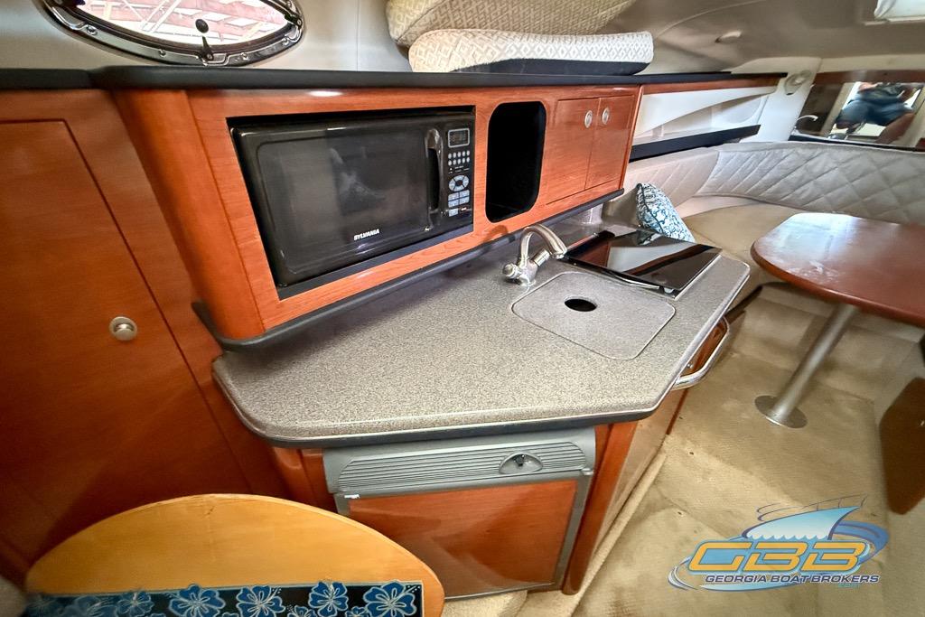 Interior of 2006 Sea Ray Sundancer 260 with kitchenette and seating area.