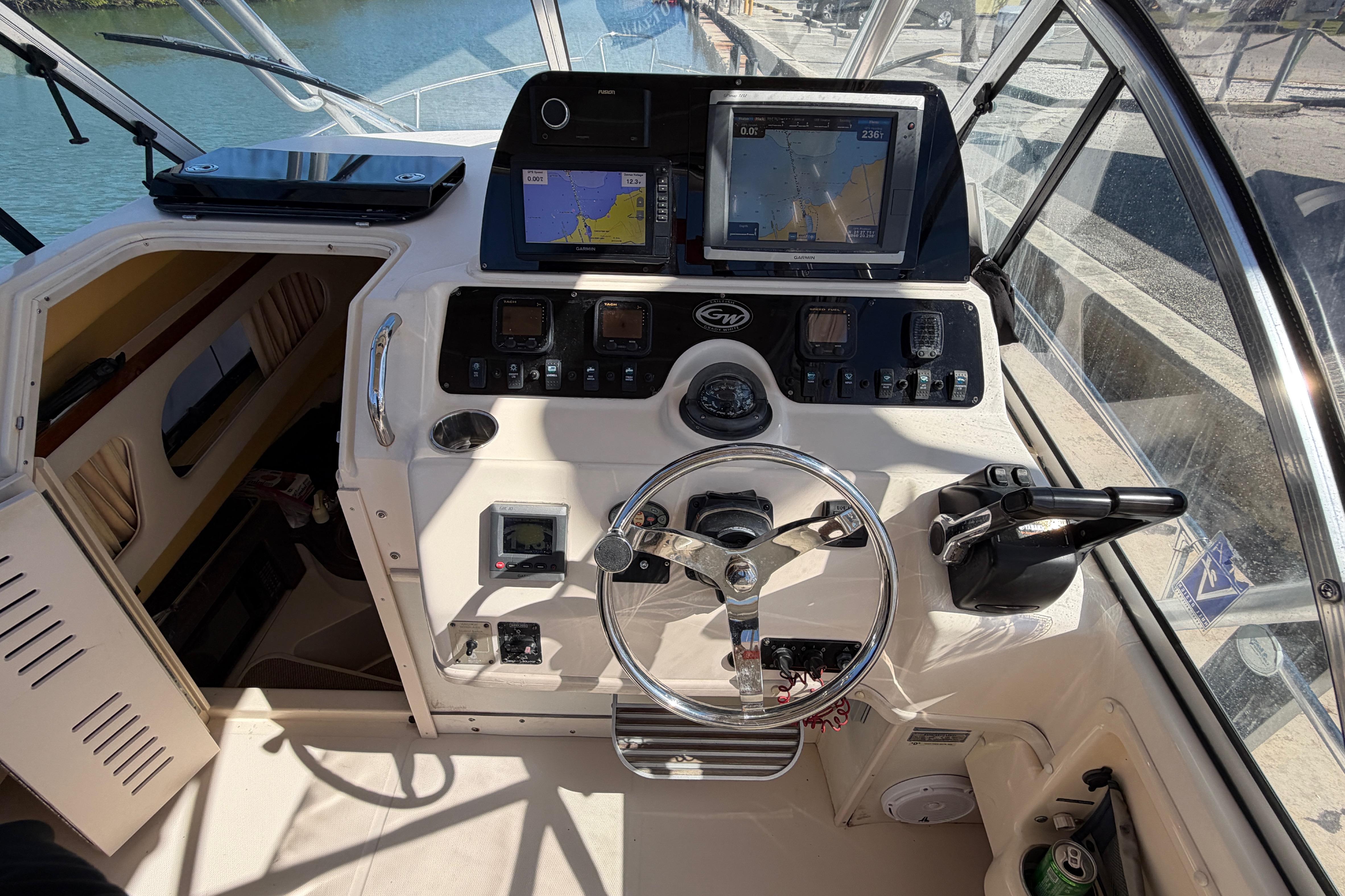 2006 Grady-White Sailfish 282 helm with navigation screens and steering wheel.