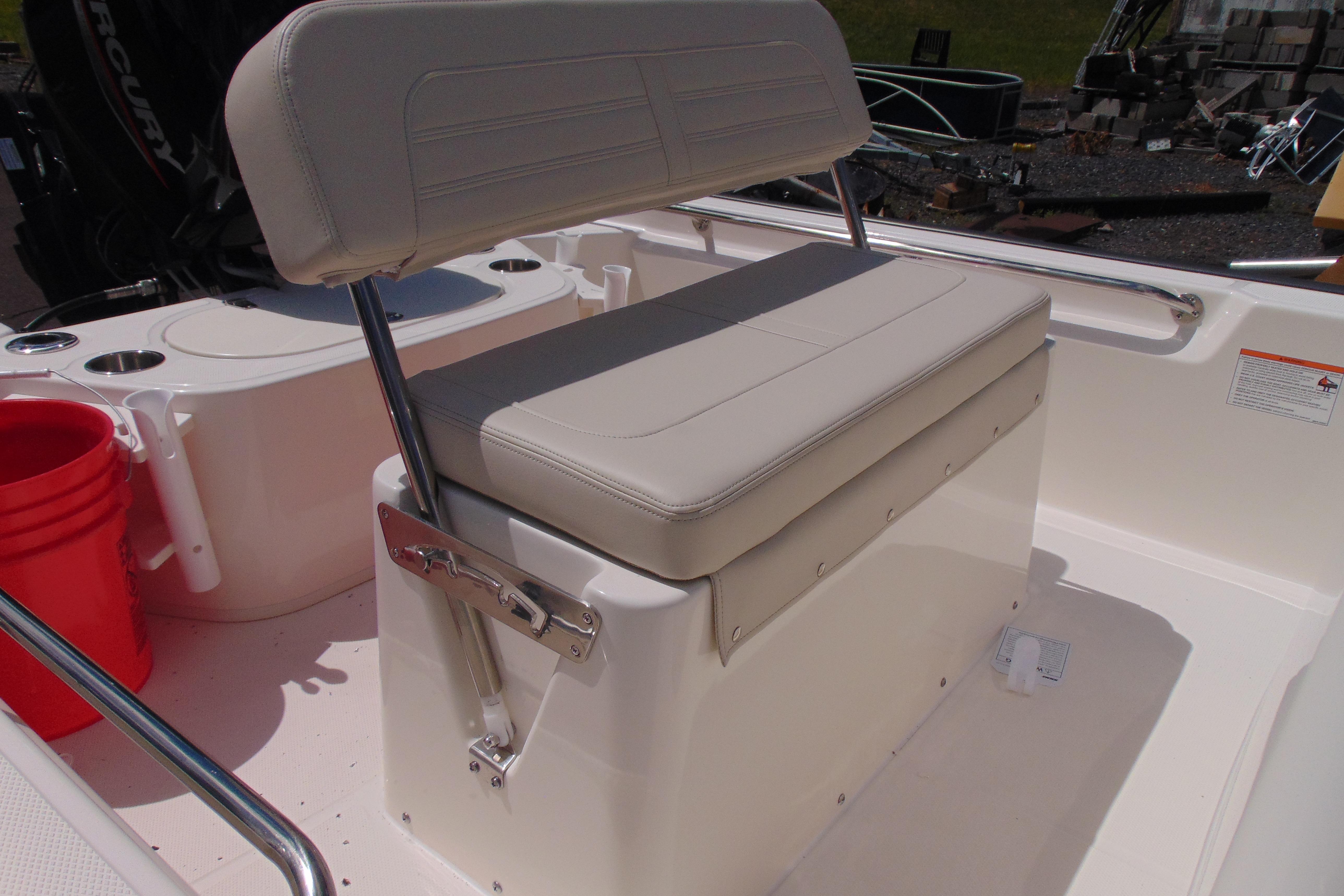 2026 Boston Whaler 150 Montauk boat seat with storage and railing.