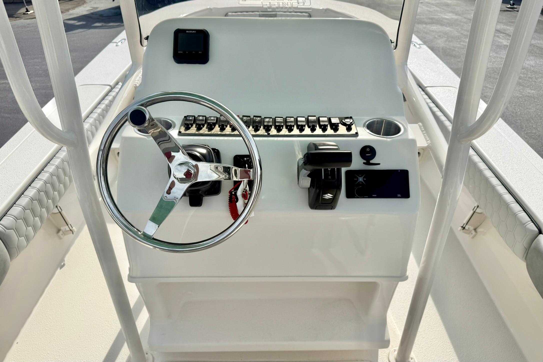 2026 Carolina Skiff 24 Ultra Elite boat console with steering wheel and controls.