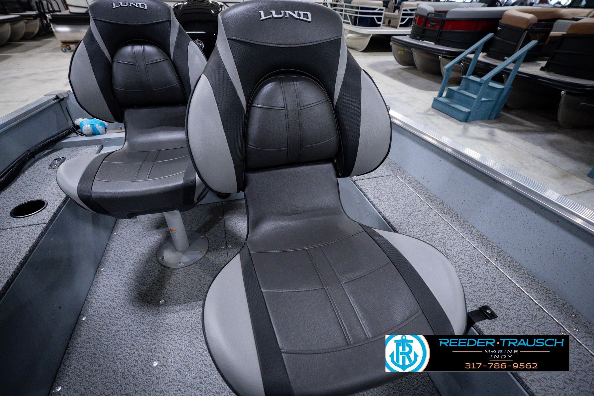 2026 Lund 1600 Fury SS boat seats in showroom, featuring sleek black and gray design.