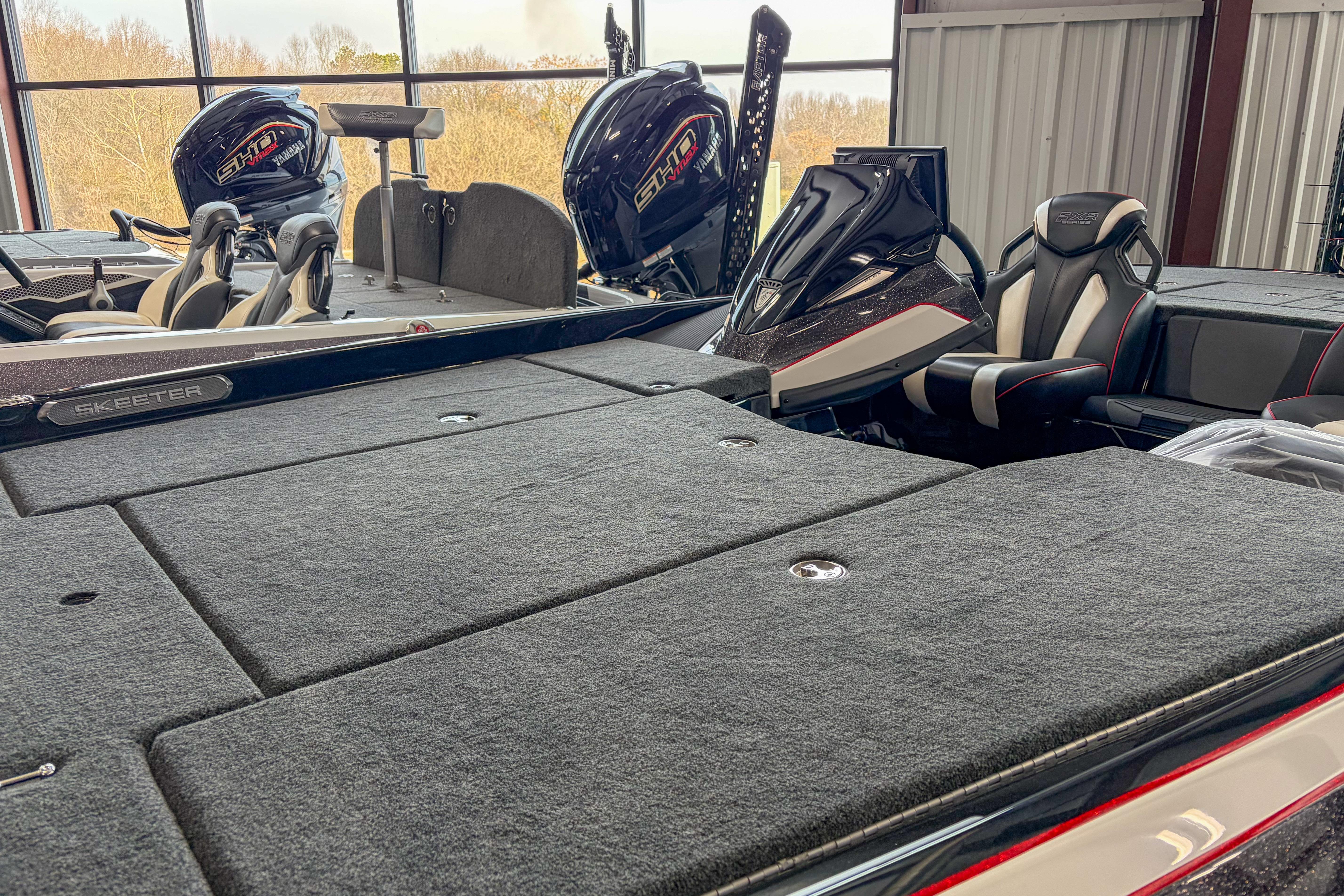 2026 Skeeter FXR20 FLEX boat interior with dual engines in a showroom.