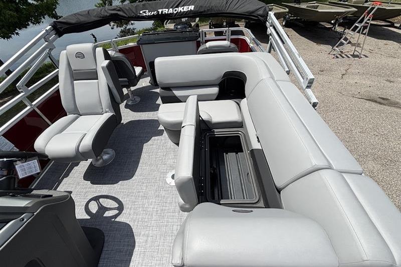 Interior of 2026 Sun Tracker SportFish 20 DLX pontoon boat with gray seating and storage.