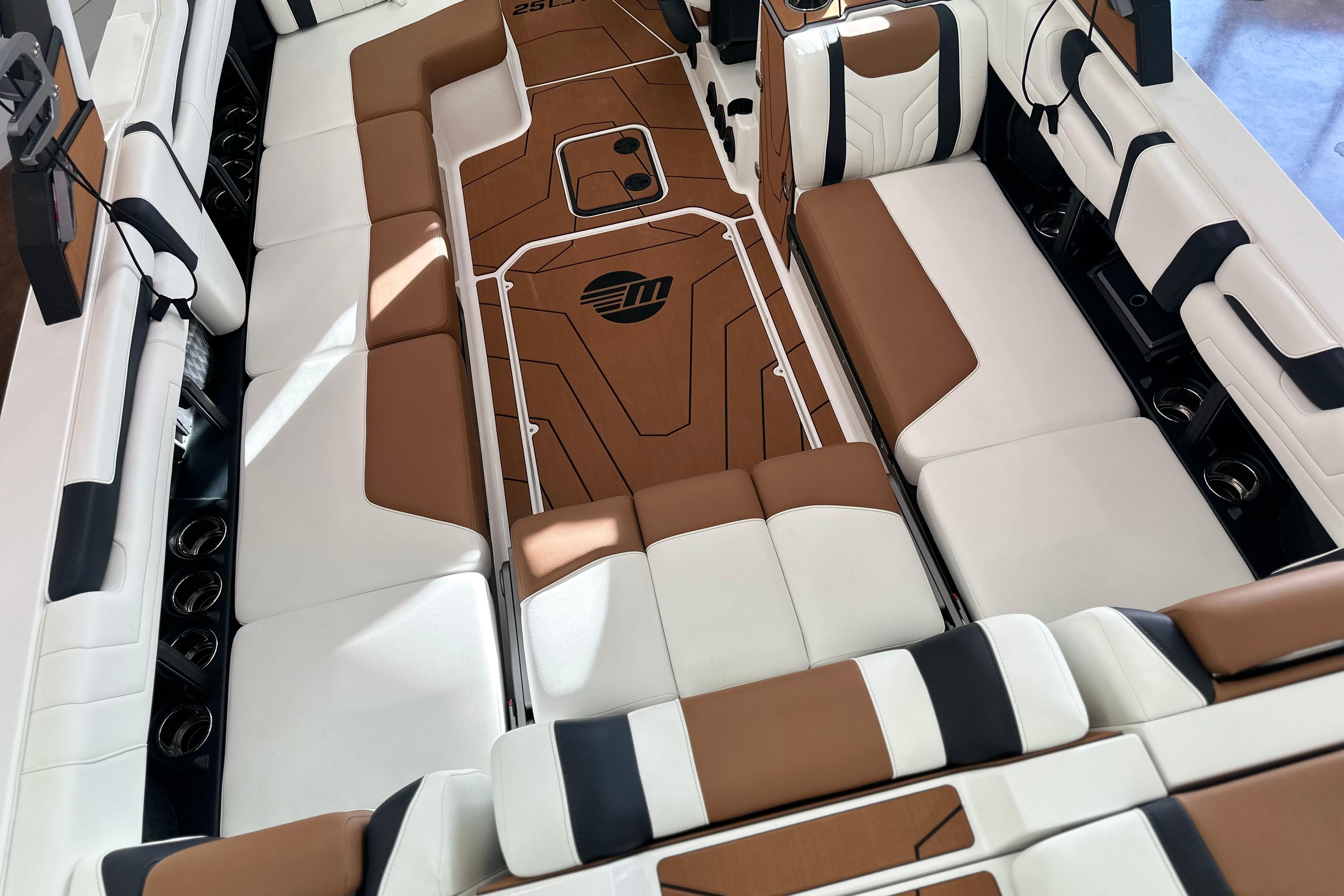 Luxurious interior of 2026 Malibu Wakesetter 25 LSV boat with brown and white seating.