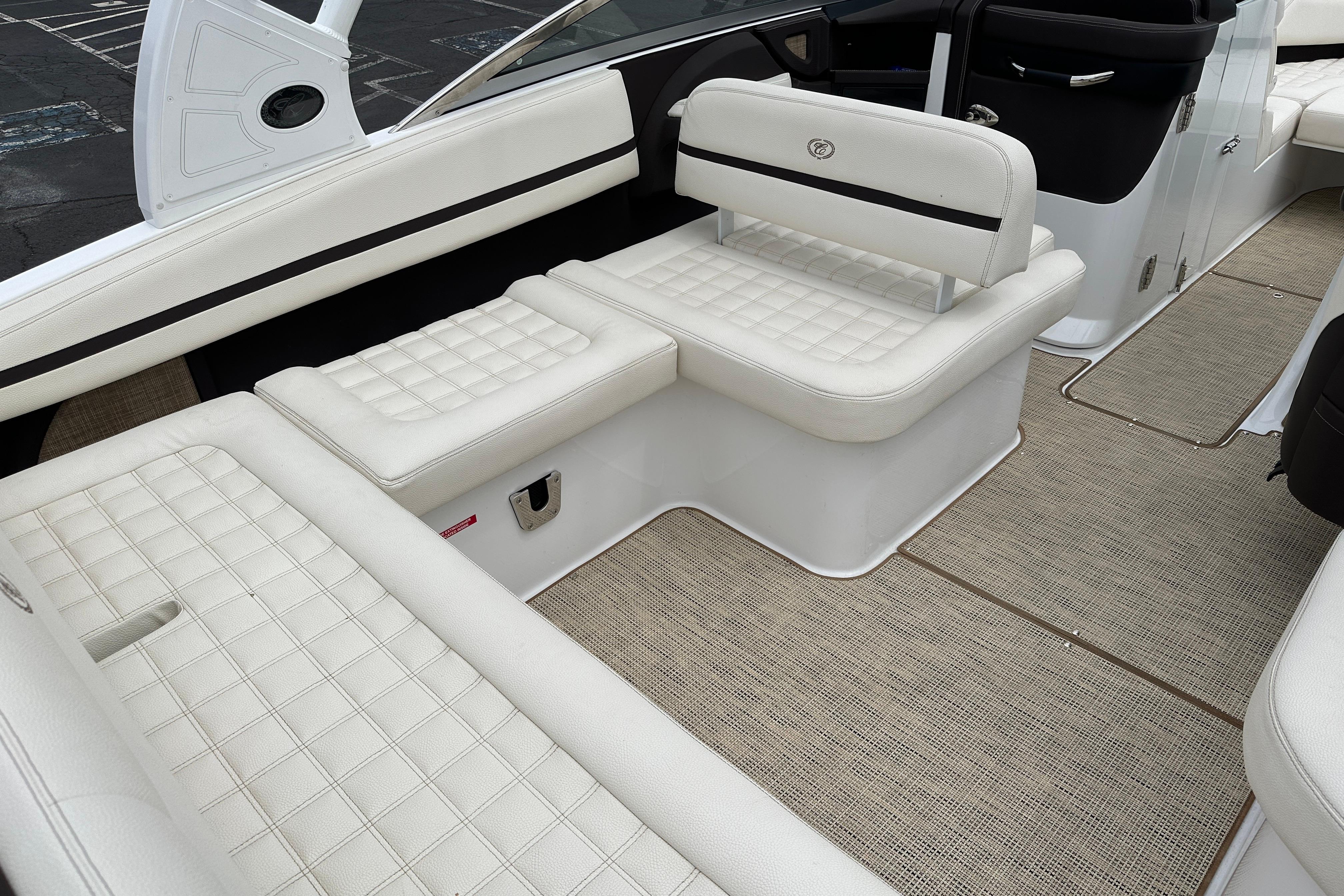 2019 Cobalt R5 boat interior with white cushioned seating and beige flooring.
