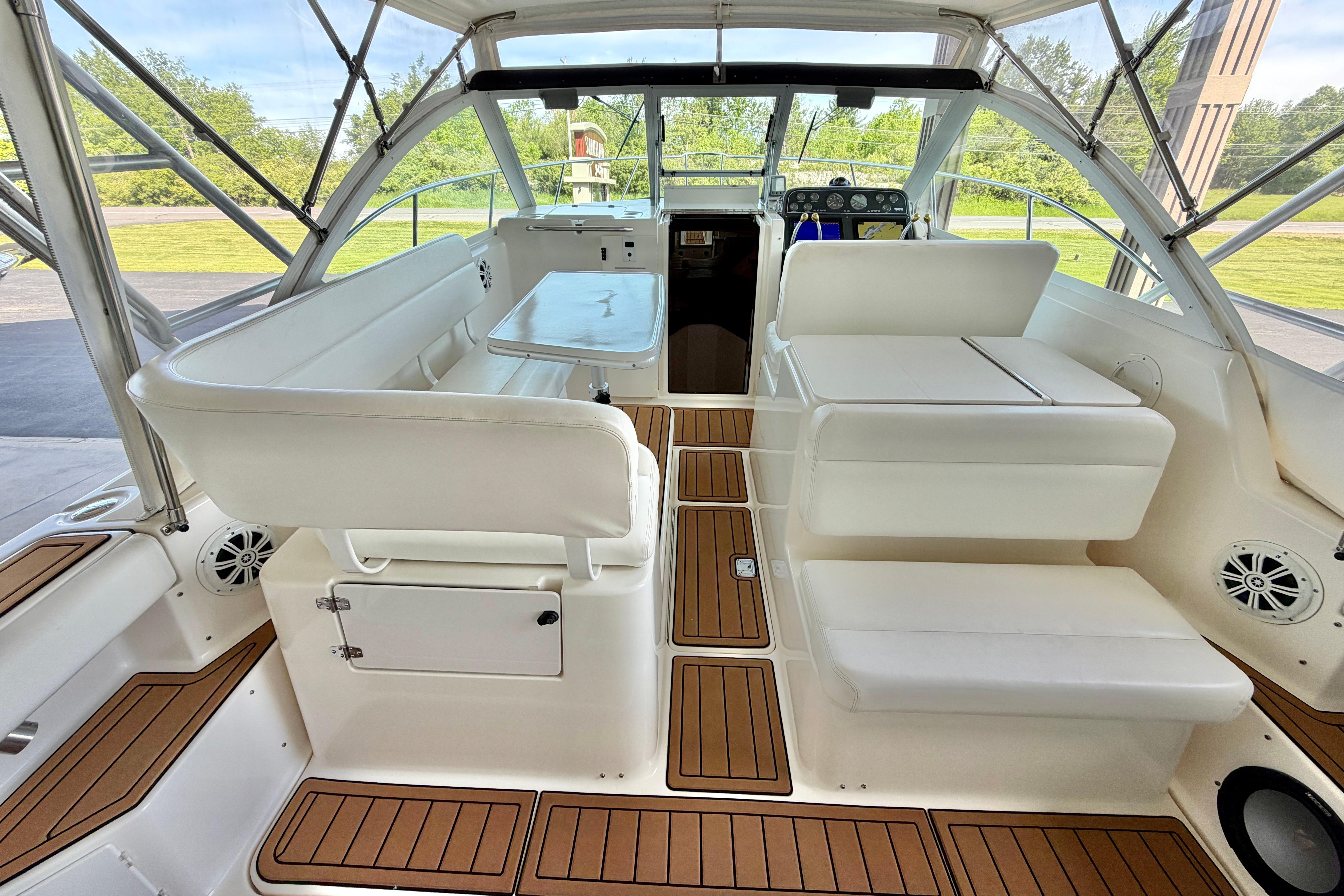 1999 Tiara Yachts 2900 Coronet interior with white seating and wooden flooring.