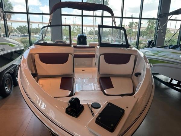 2023 Tahoe 185 S boat interior with seating and dashboard, displayed indoors.