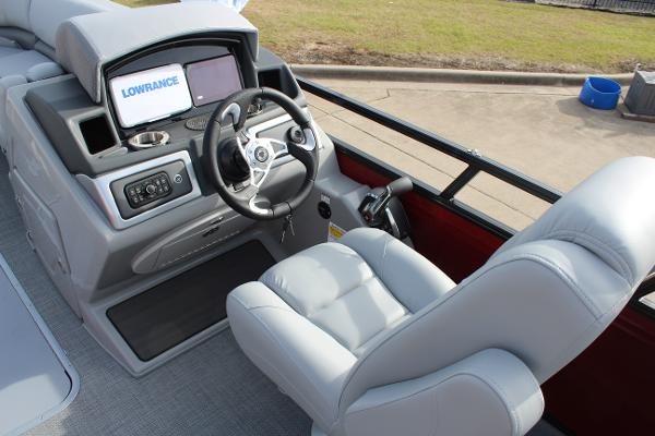 2025 Regency 230 DL3 boat cockpit with steering wheel and Lowrance display.