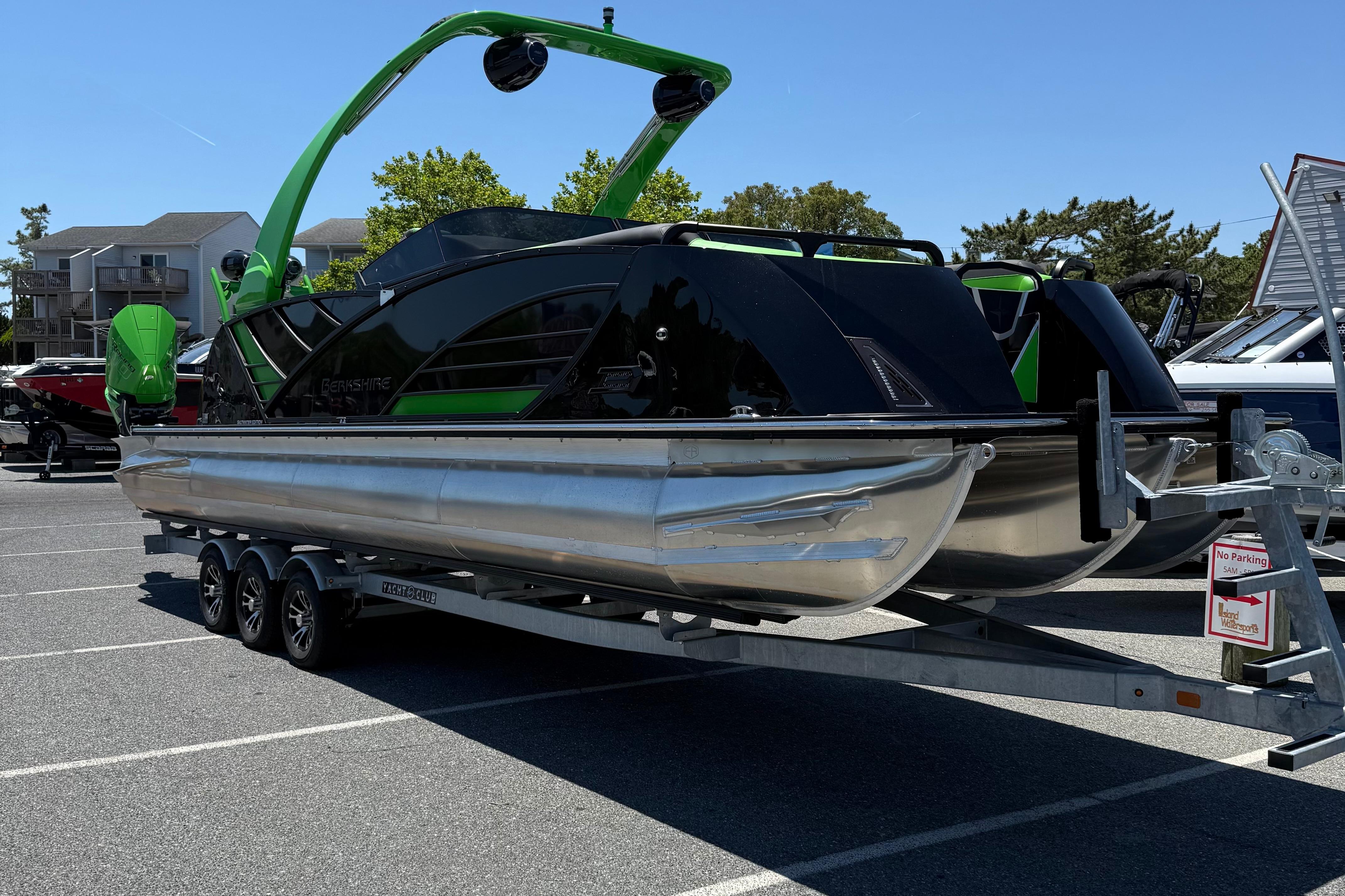 2026 Berkshire Sport SLX9 DC pontoon boat on trailer, featuring sleek black and green design.