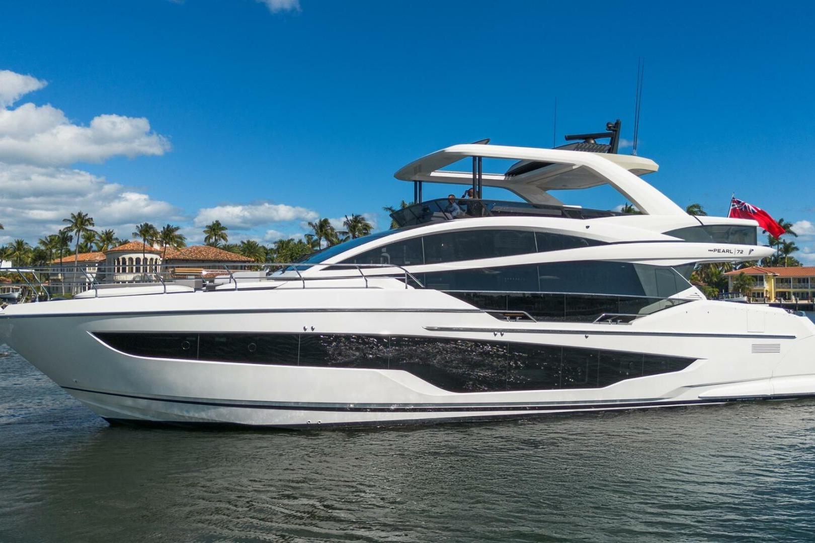 Luxurious 2023 Pearl 72 yacht cruising on a sunny day with palm trees in the background.