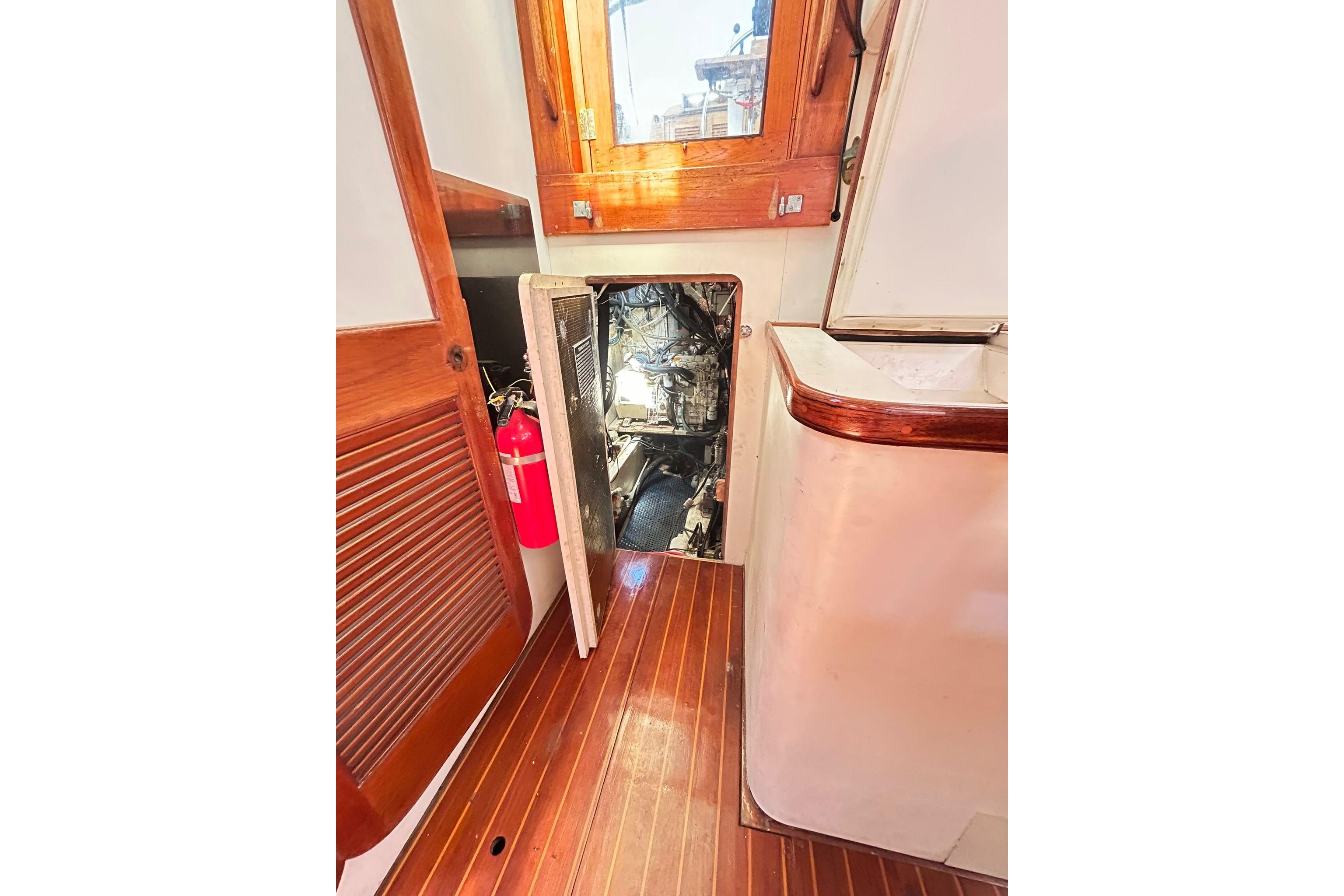 1987 Gulfstar CSY 50 Pilot House interior with engine access and fire extinguisher.