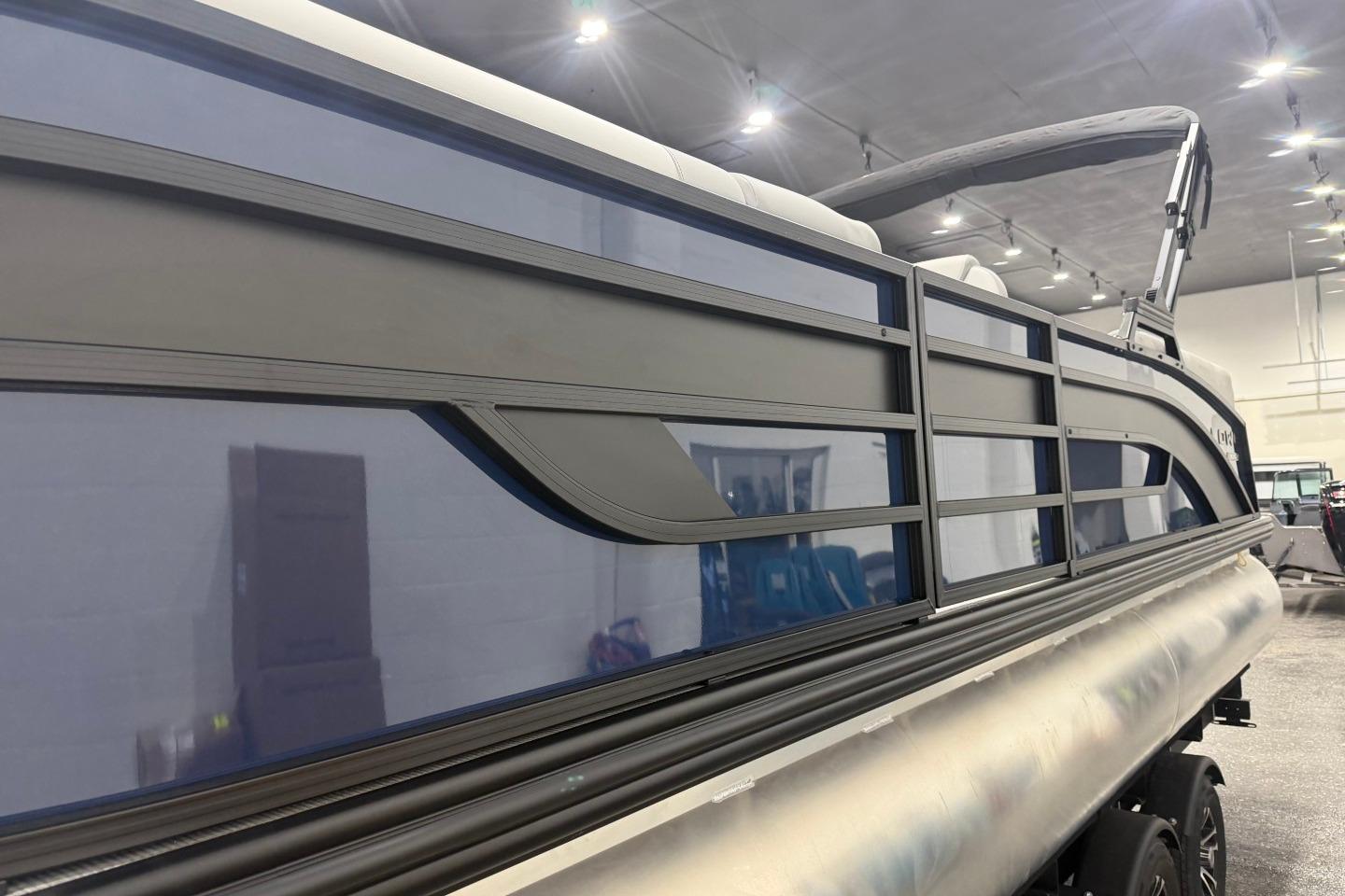 2026 Lowe SS 230 WT pontoon boat in showroom, showcasing sleek design and modern features.