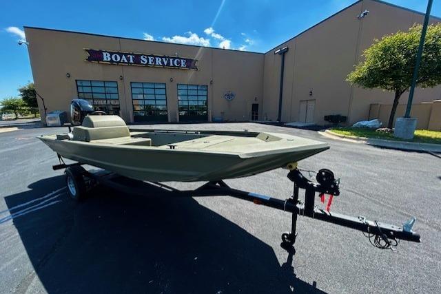2026 Tracker Grizzly 1648 SC boat on trailer outside service center.
