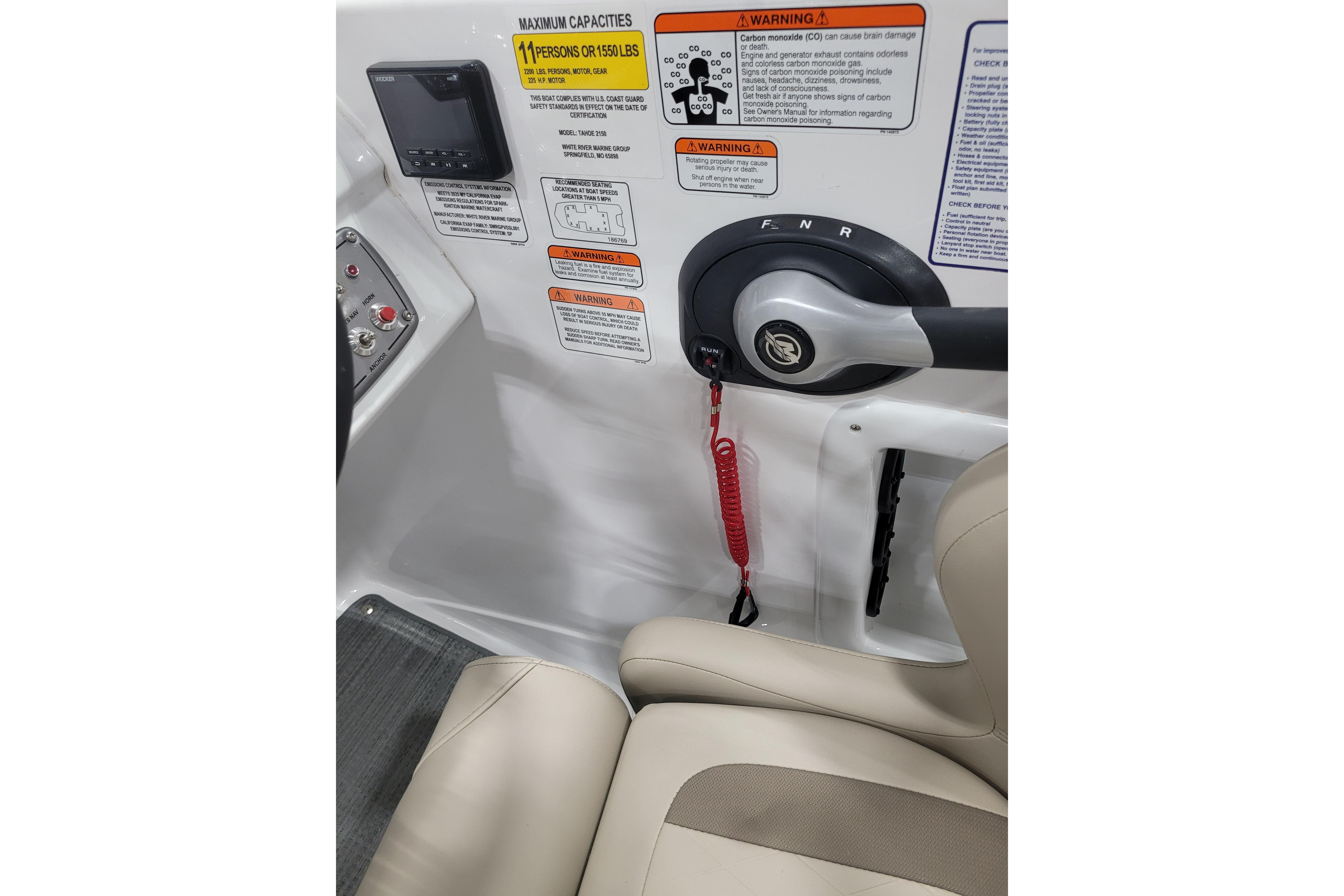 Control panel of 2026 Tahoe 2150 boat with safety warnings and throttle lever.