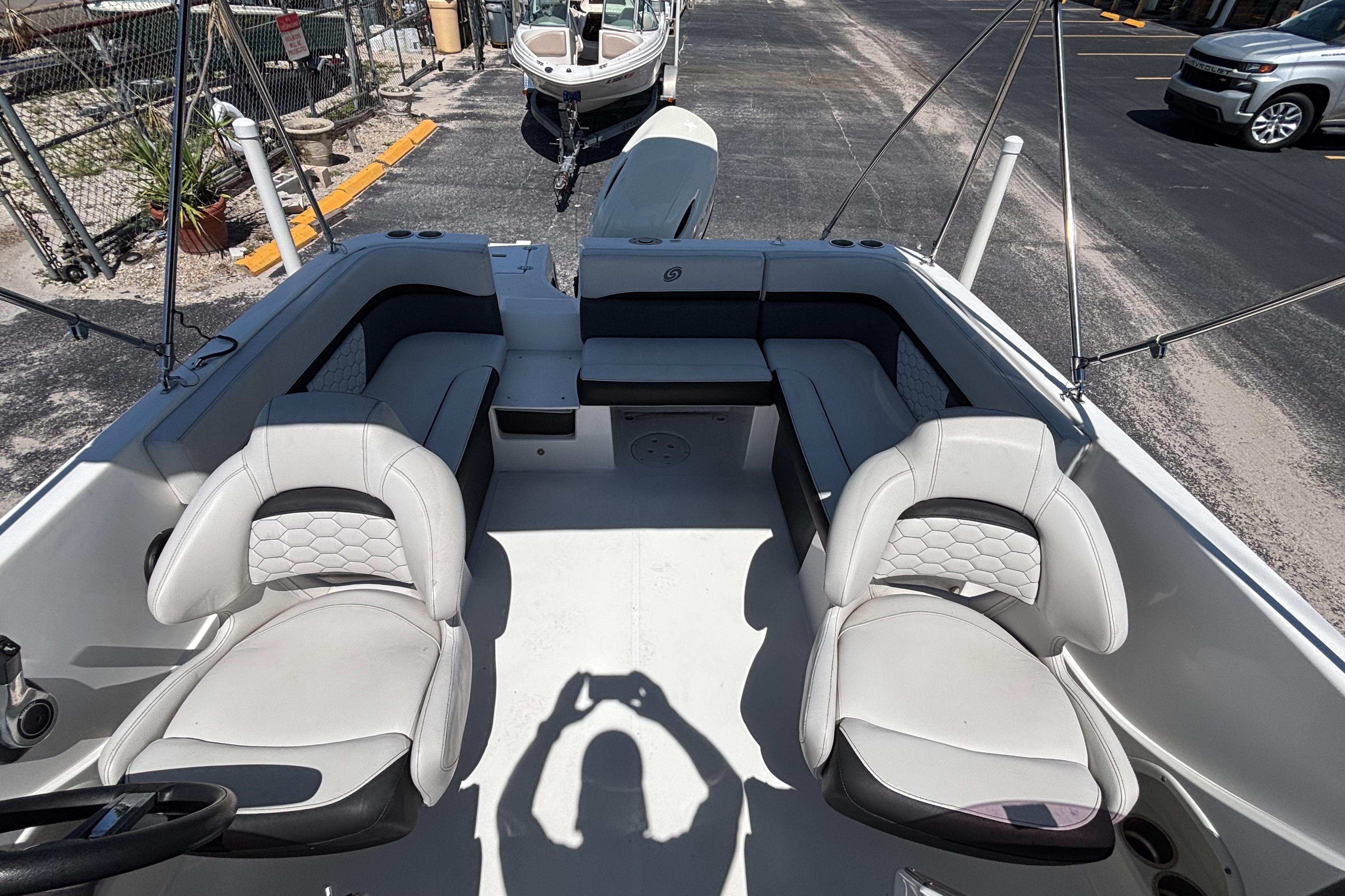 2019 Hurricane Sundeck Sport 218 OB boat interior with seating and steering wheel.