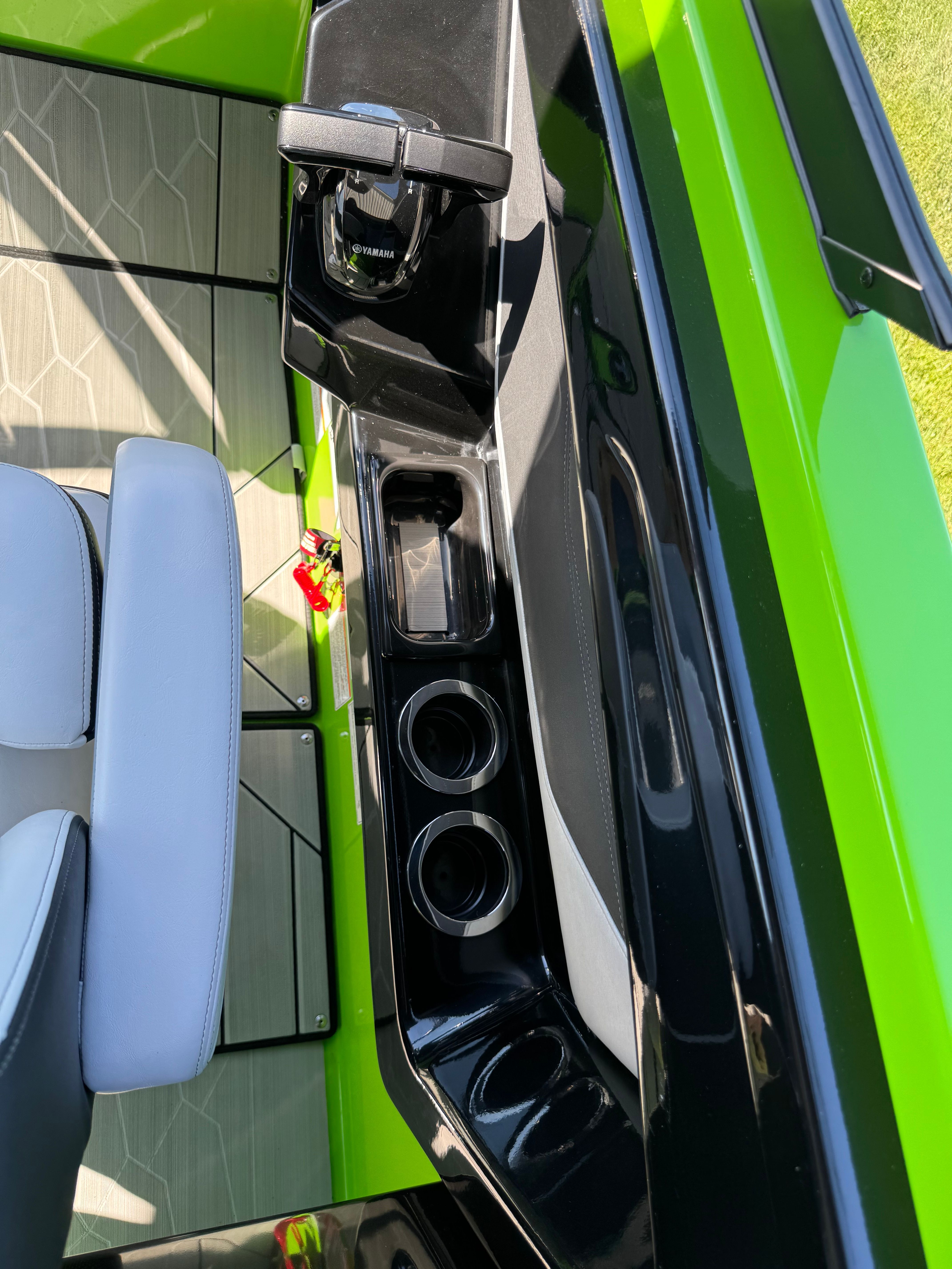 Close-up of the helm area of a 2022 Yamaha 255XD with green accents.