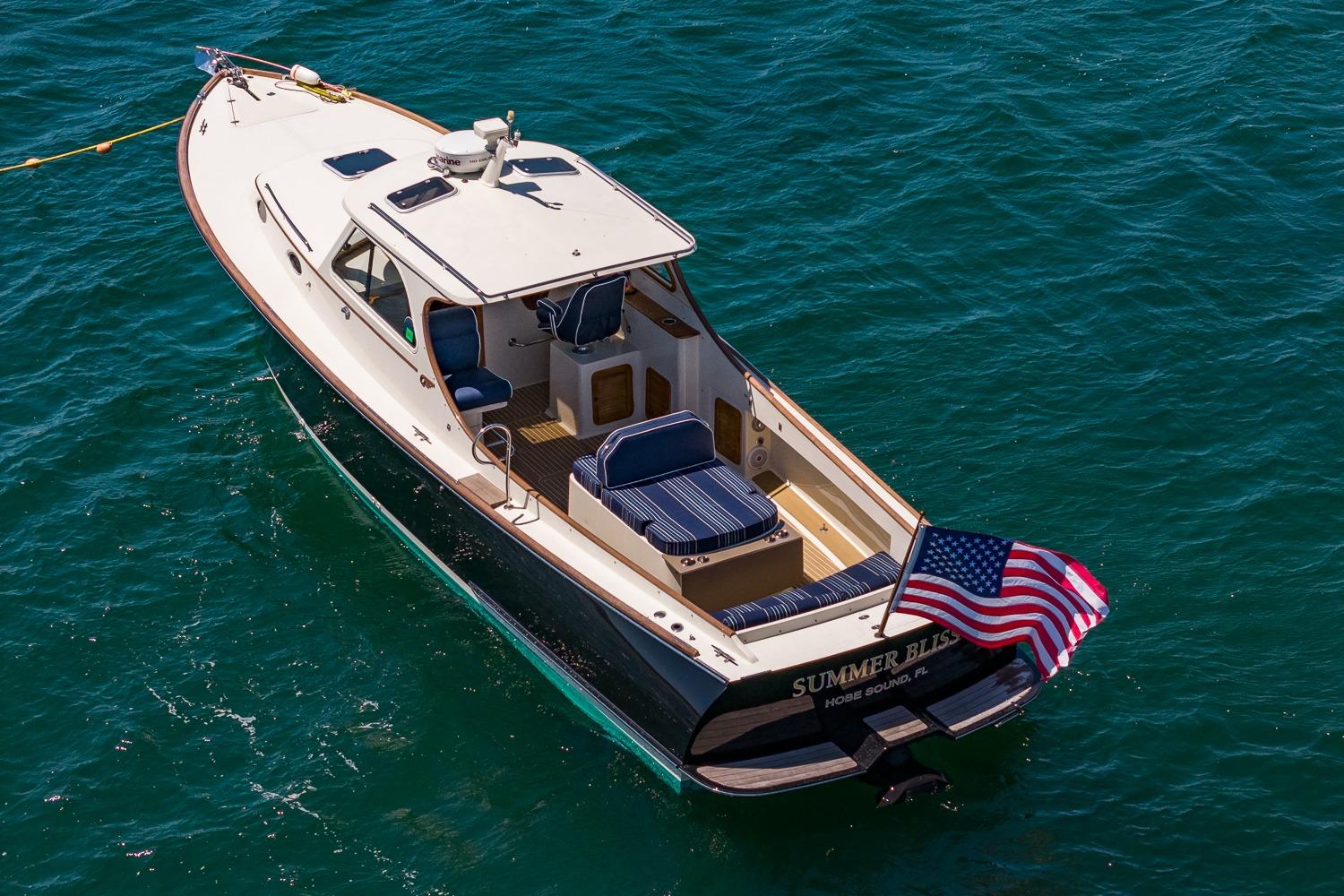 2001 Hinckley Picnic Boat 36 Classic cruising on clear blue water.
